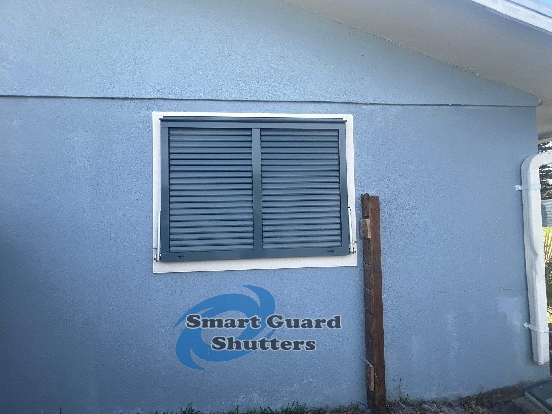 Impact Bahama Shutters in Grey Blue by Smart Guard Shutters
