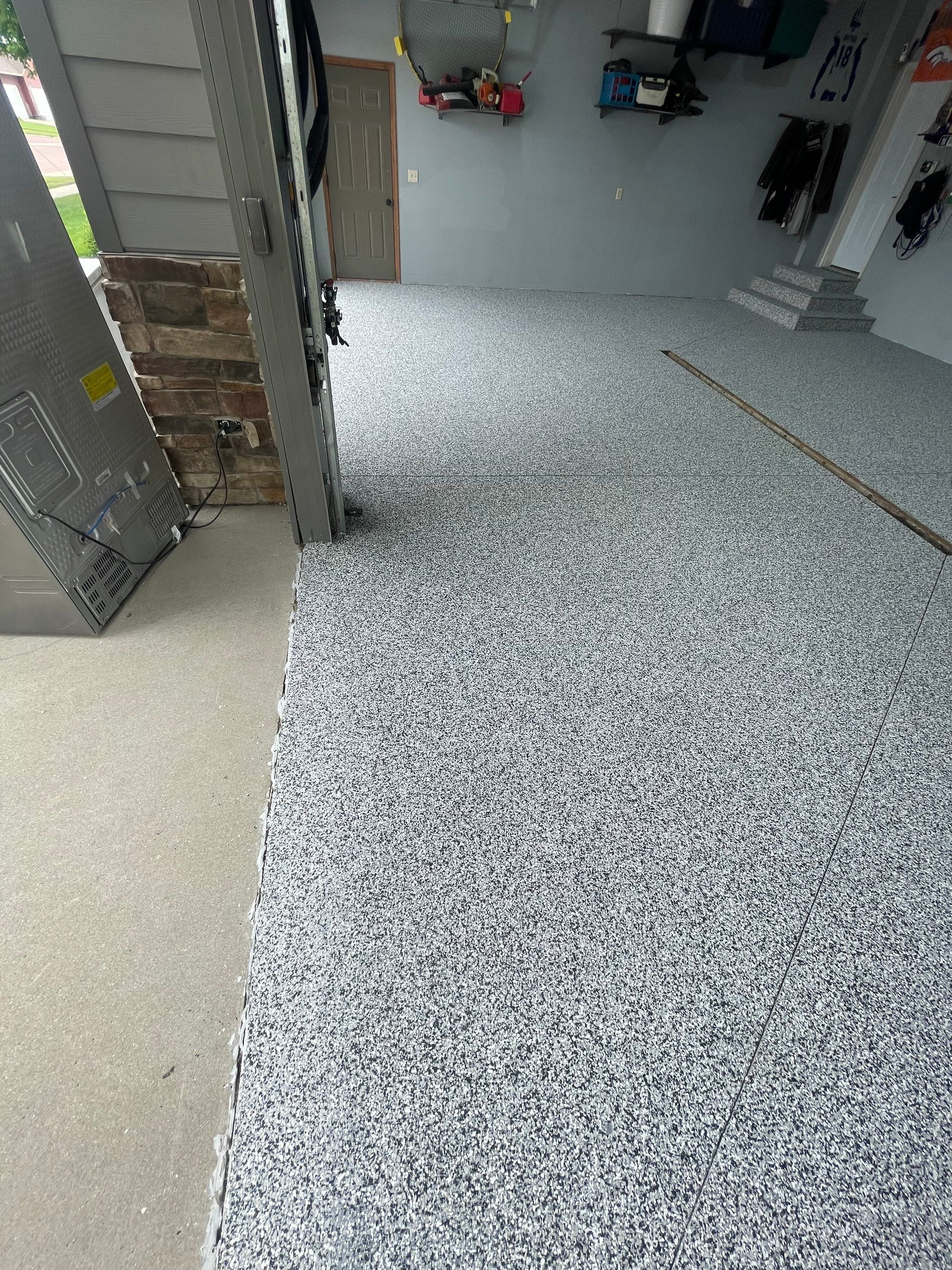 Full Garage Floor Epoxy Coating Installation in Dell Rapids by Select Painting, Coatings & Garage Cabinets