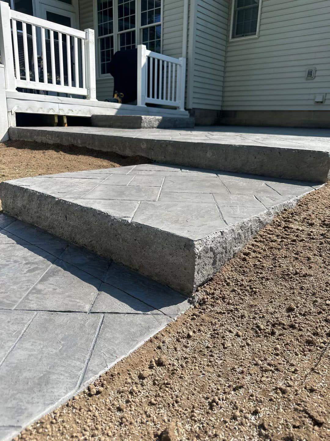 Majestic ashlar stamped concrete patio  by NG Masonry & Construction LLC