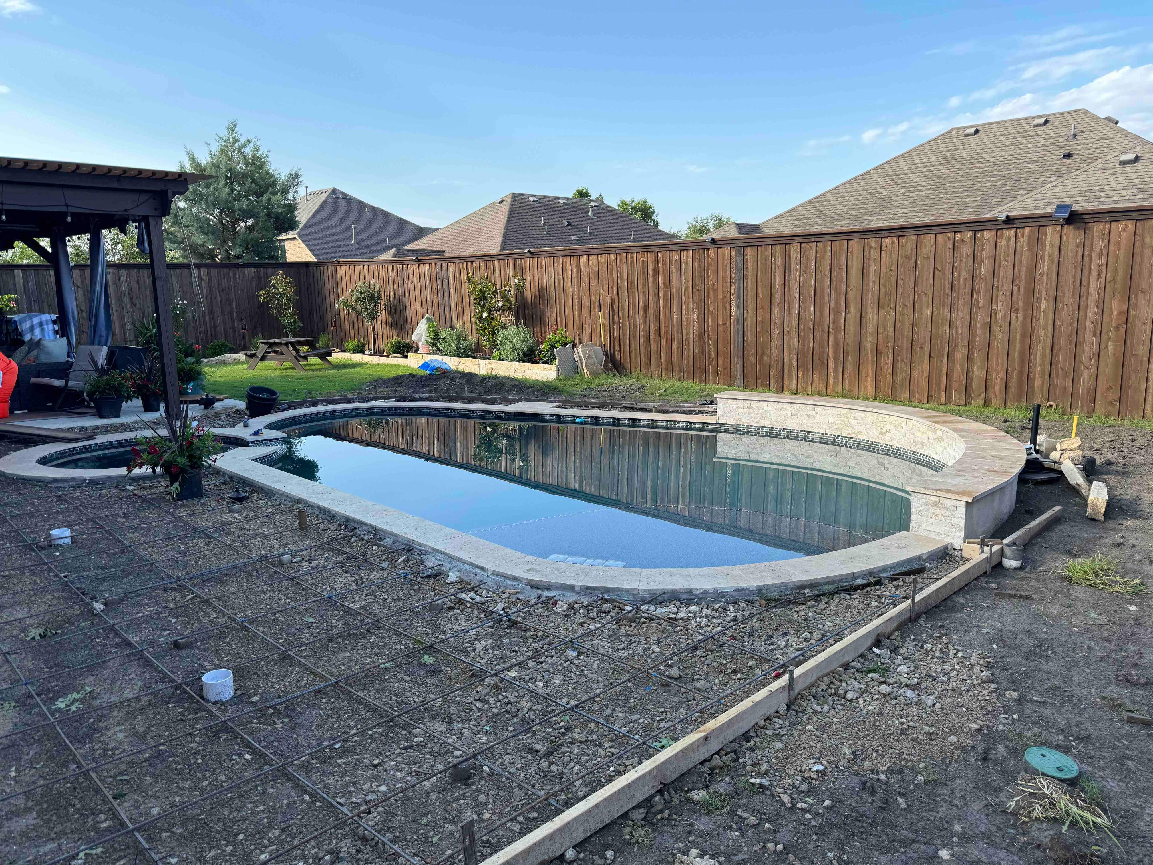 Freeform Pool with Raised Spa and Stone Veneer by Pinnacle Pools and Spas - DFW