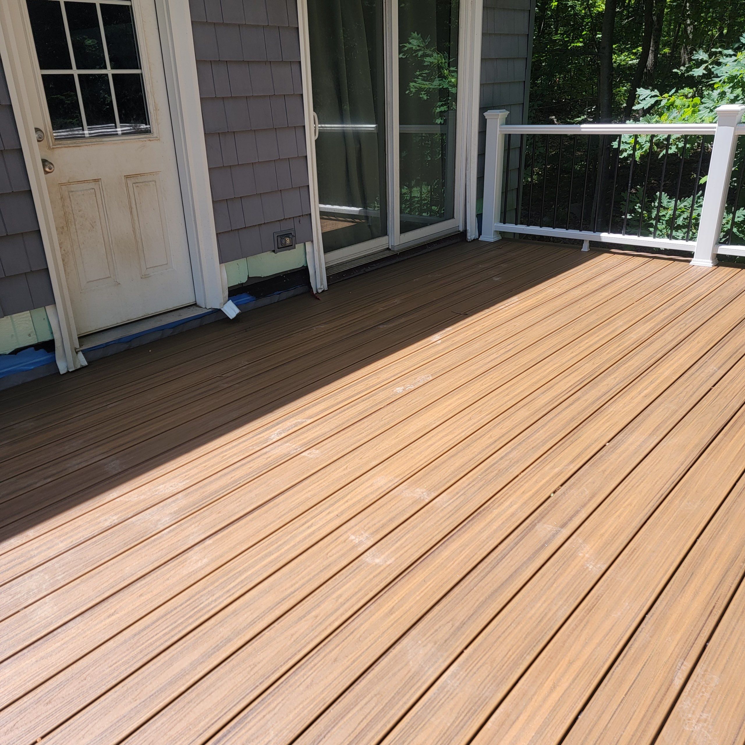 Deck replacement using trex tropical Havana Gold and transcend white railings by DiGiorgi Roofing and Siding Inc