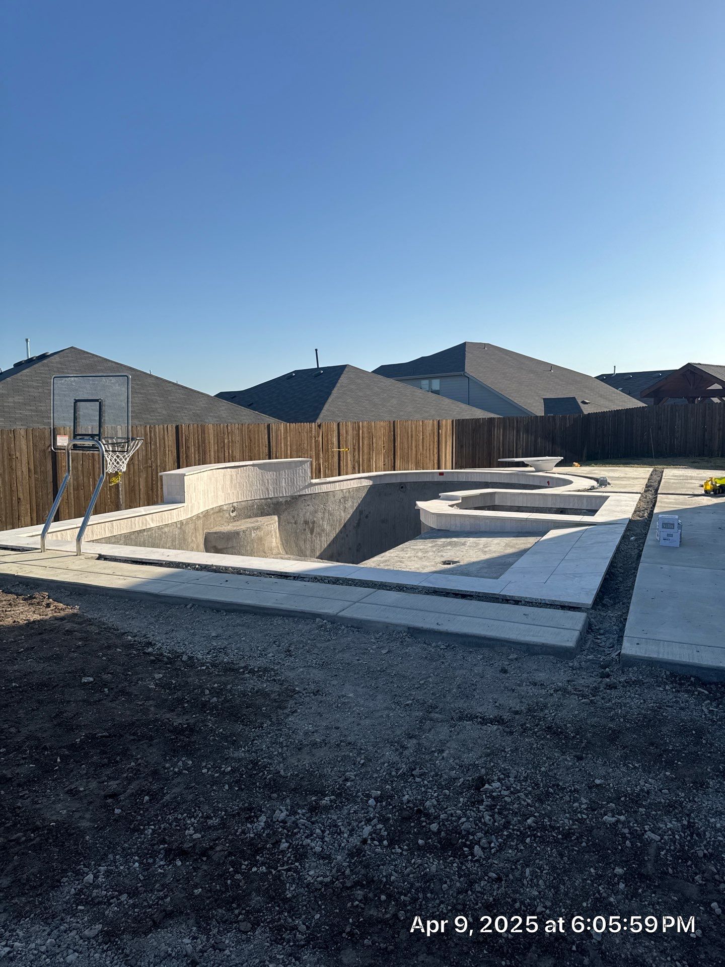 Geometric Pool with Spillover Spa and Dark Interior by Pinnacle Pools and Spas - DFW