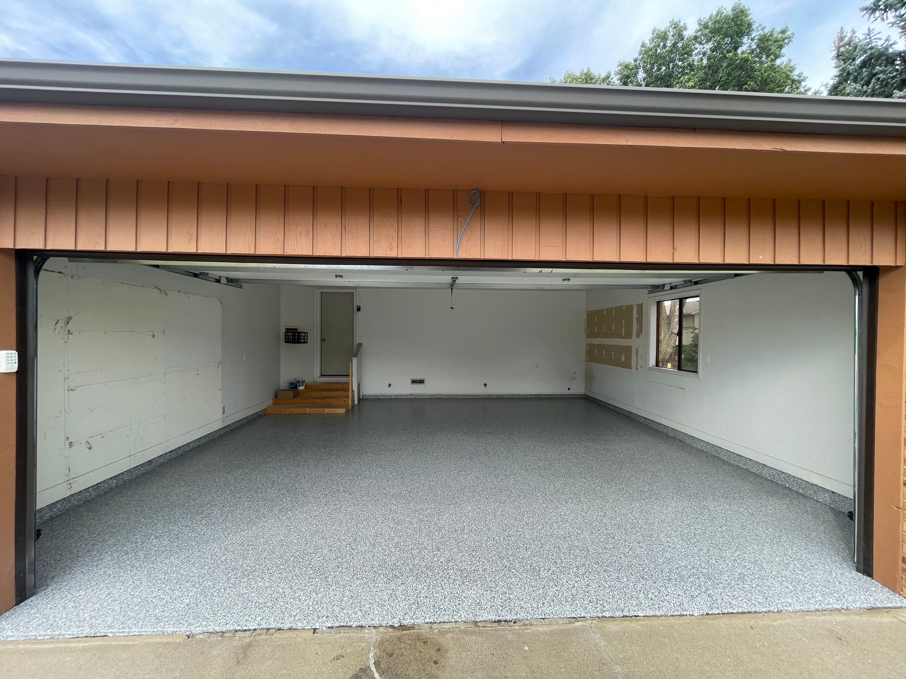 Grey Speckled Concrete Coating for Residential Garage in Yankton by Select Painting, Coatings & Garage Cabinets