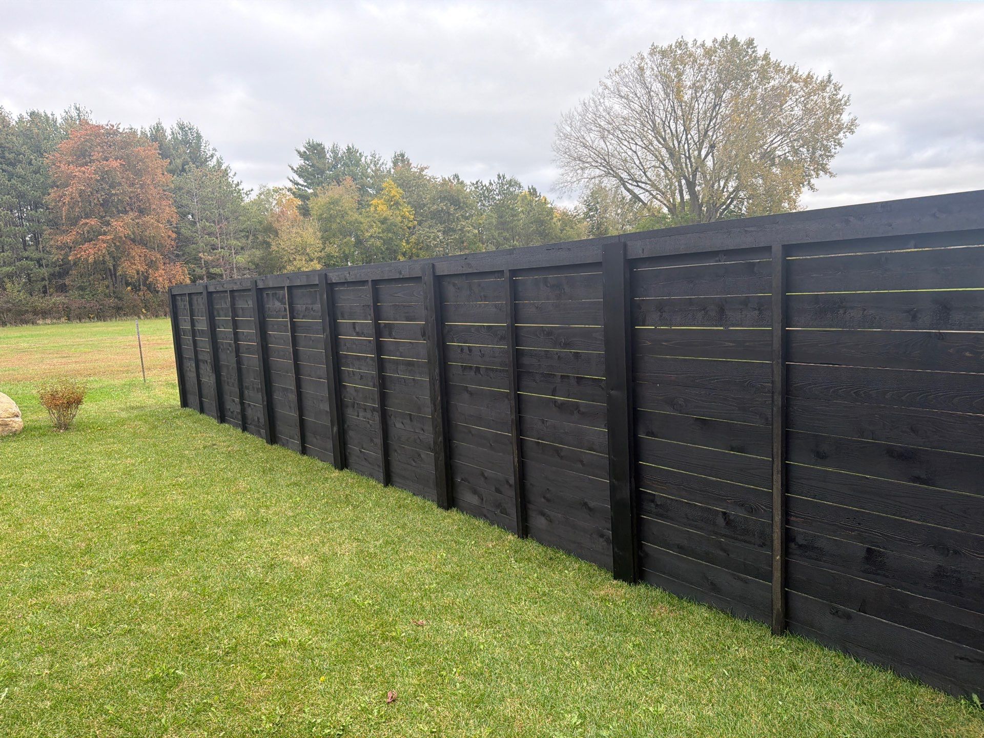 Modern Horizontal Wood Privacy Fence Installation in Cedar Falls by Perfect Picket Fence and Stain