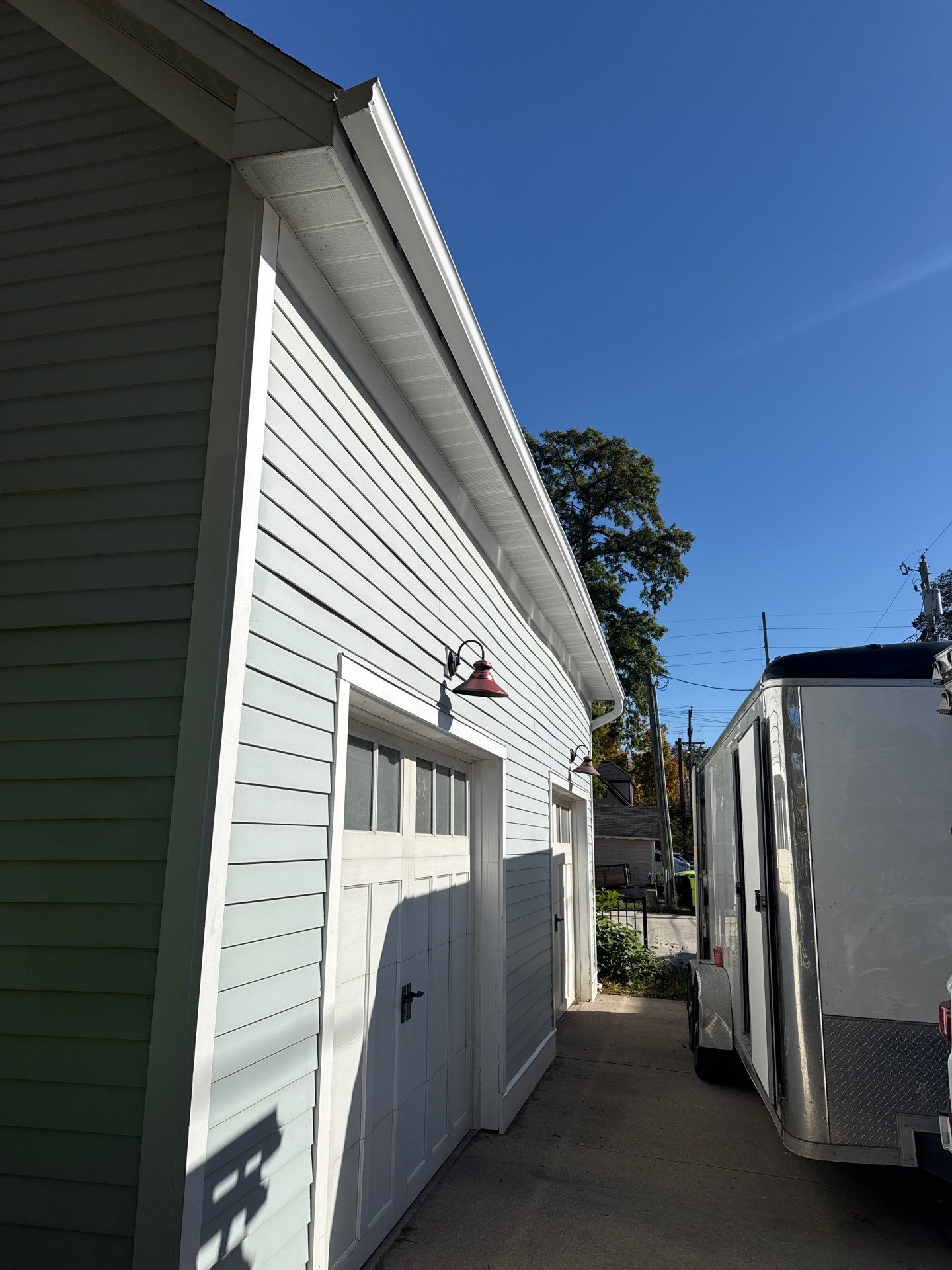 Seamless Gutter and Downspout Installation for Traverse City Garage by Rainbow Seamless Systems