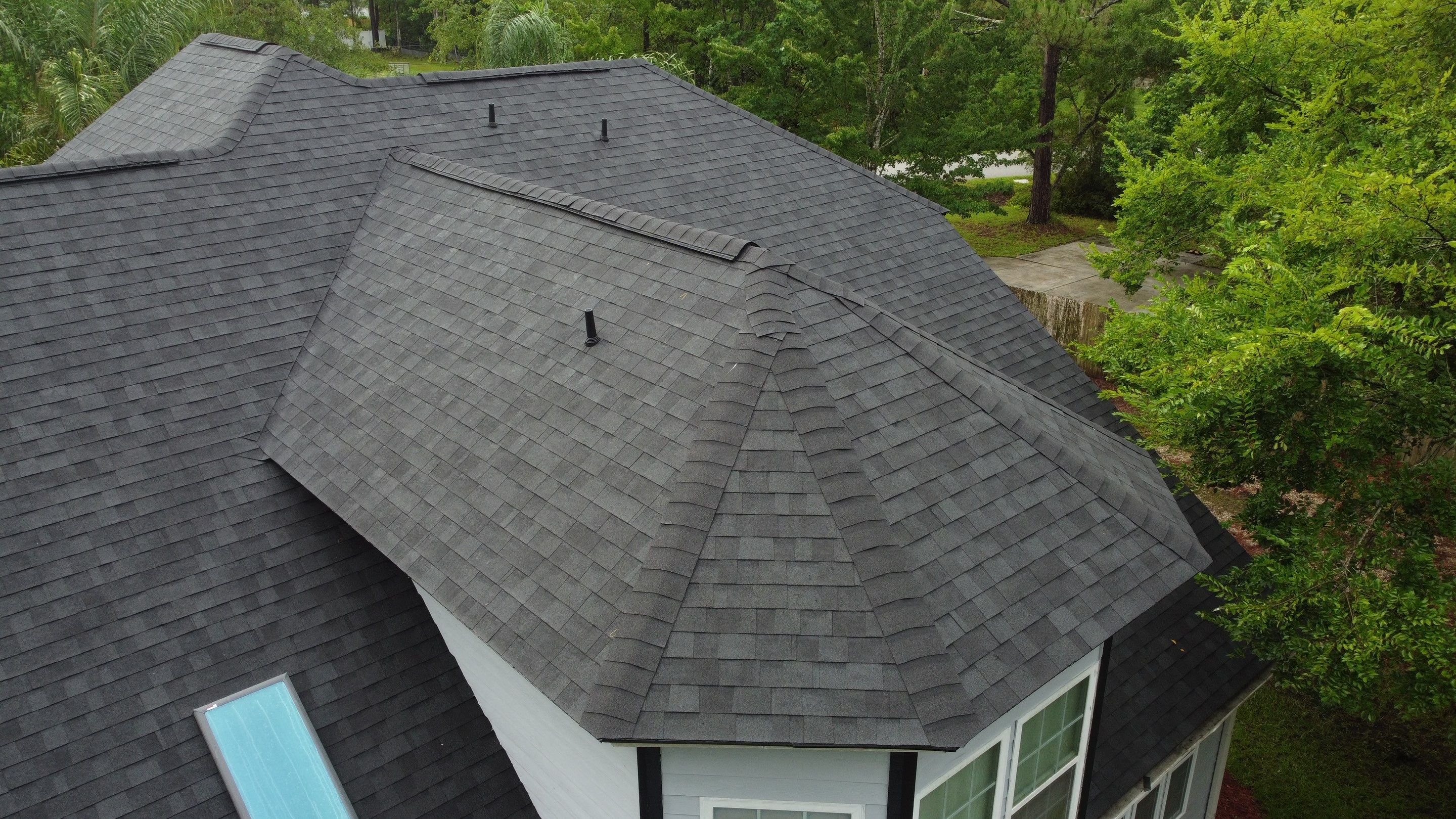 Complete Onyx Black Asphalt Shingle Roof Replacement and Skylight Installation in Jacksonville by Trinity Restoration and Roofing LLC