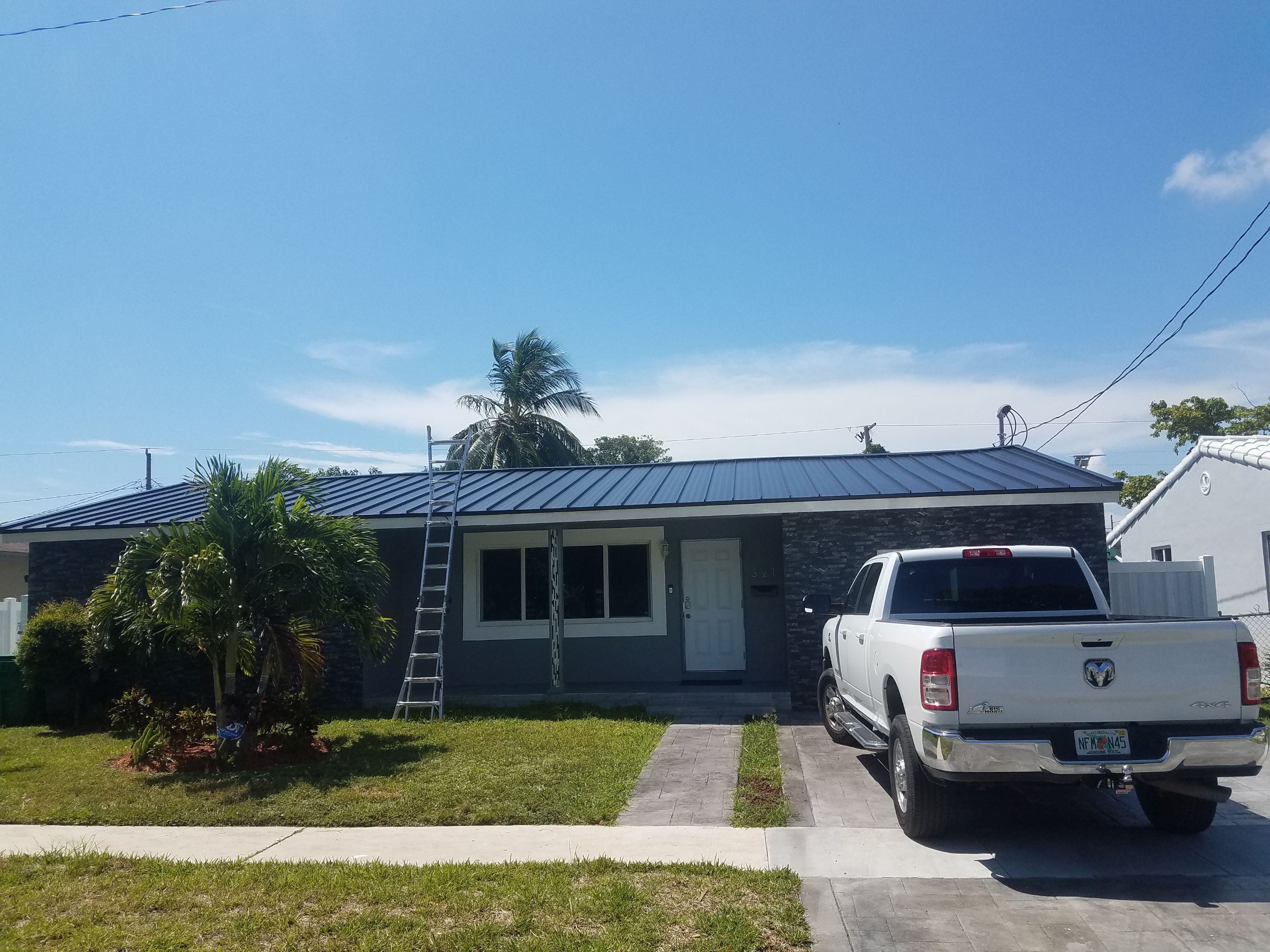 Standing Seam Metal & Flat Re-Roof using 1.5" Nail Strip 24ga Black Matte Kynar Coated Standing Seam Metal Panels by Morton Roofing, Inc.
