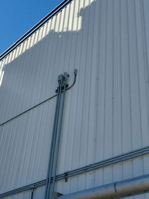 Exterior view of metal wall panels and conduit