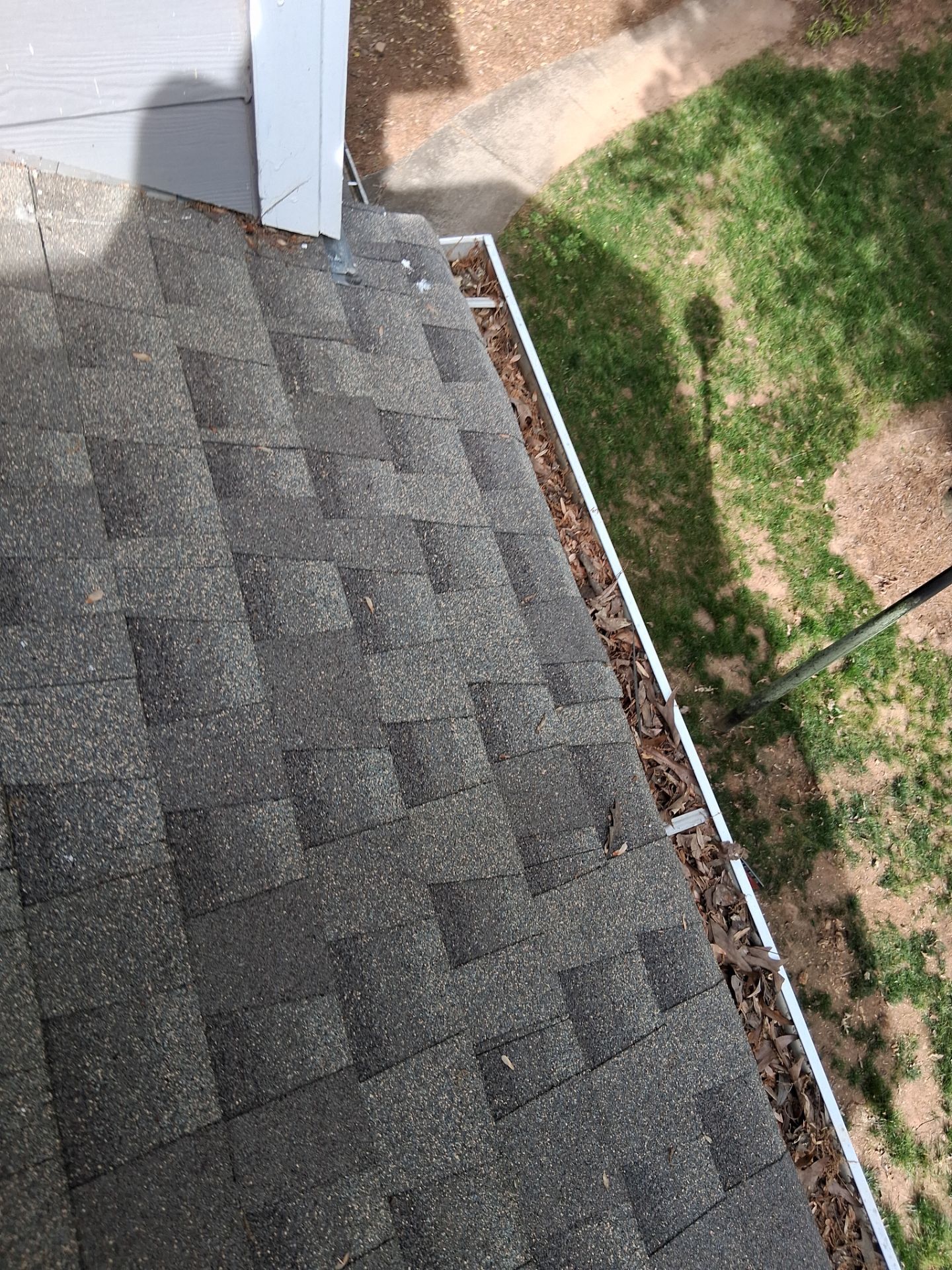 HOA gutter cleaning in Huntersville, NC,before photo showing full gutters.