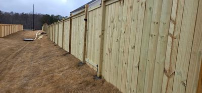 Fence Installation of Capped Wood Privacy with dado cut posts