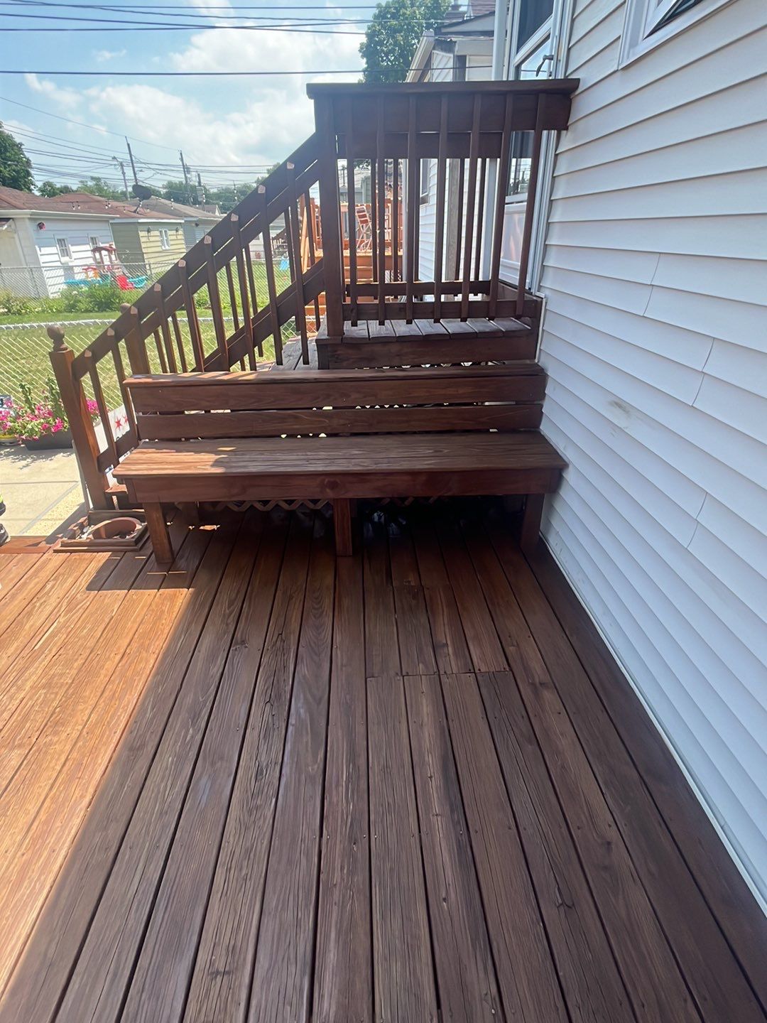 Wood cleaning and staining using Armstrong cloark oil stain by Northern Power Washing LLC.