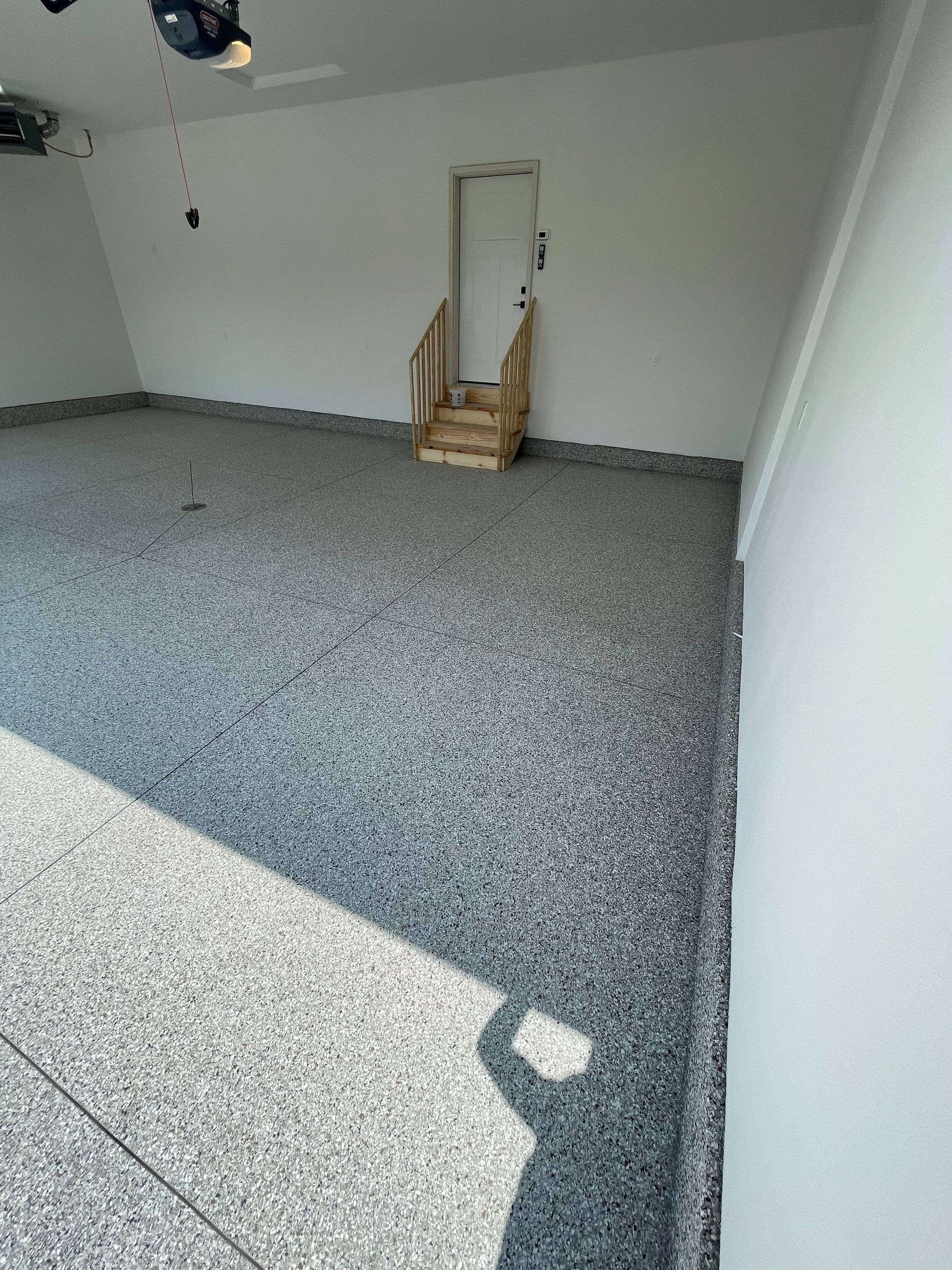 Grey Speckled Garage Floor Coating in Sioux Falls by Select Painting, Coatings & Garage Cabinets