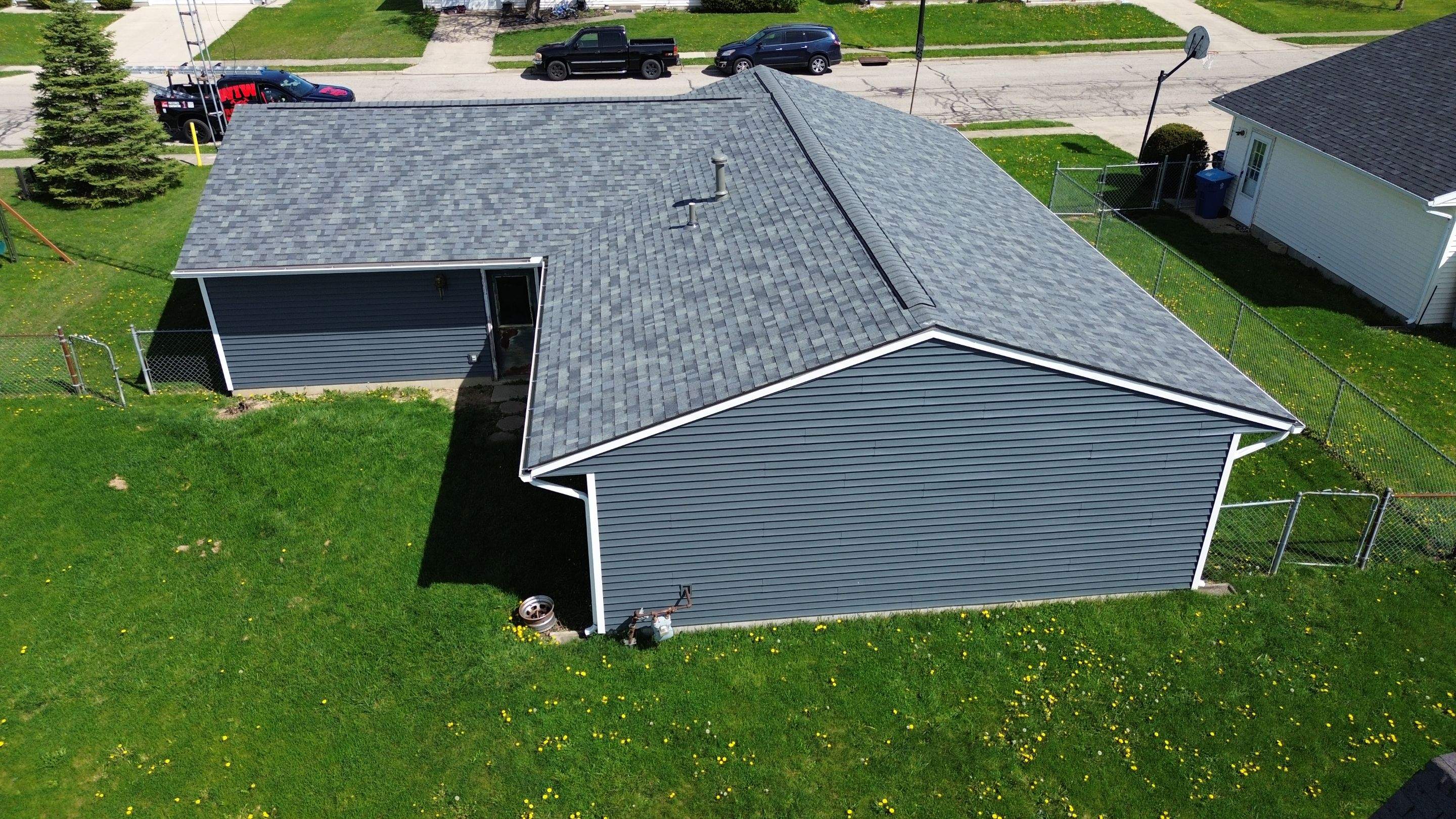 Storm Damage Residential Roof and Siding Installation by WIW Enterprises Inc