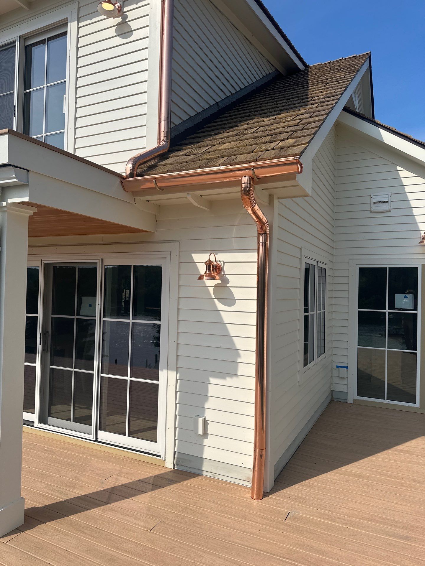 Custom Copper Gutter System and Accent Roofing in East Jordan by Rainbow Seamless Systems