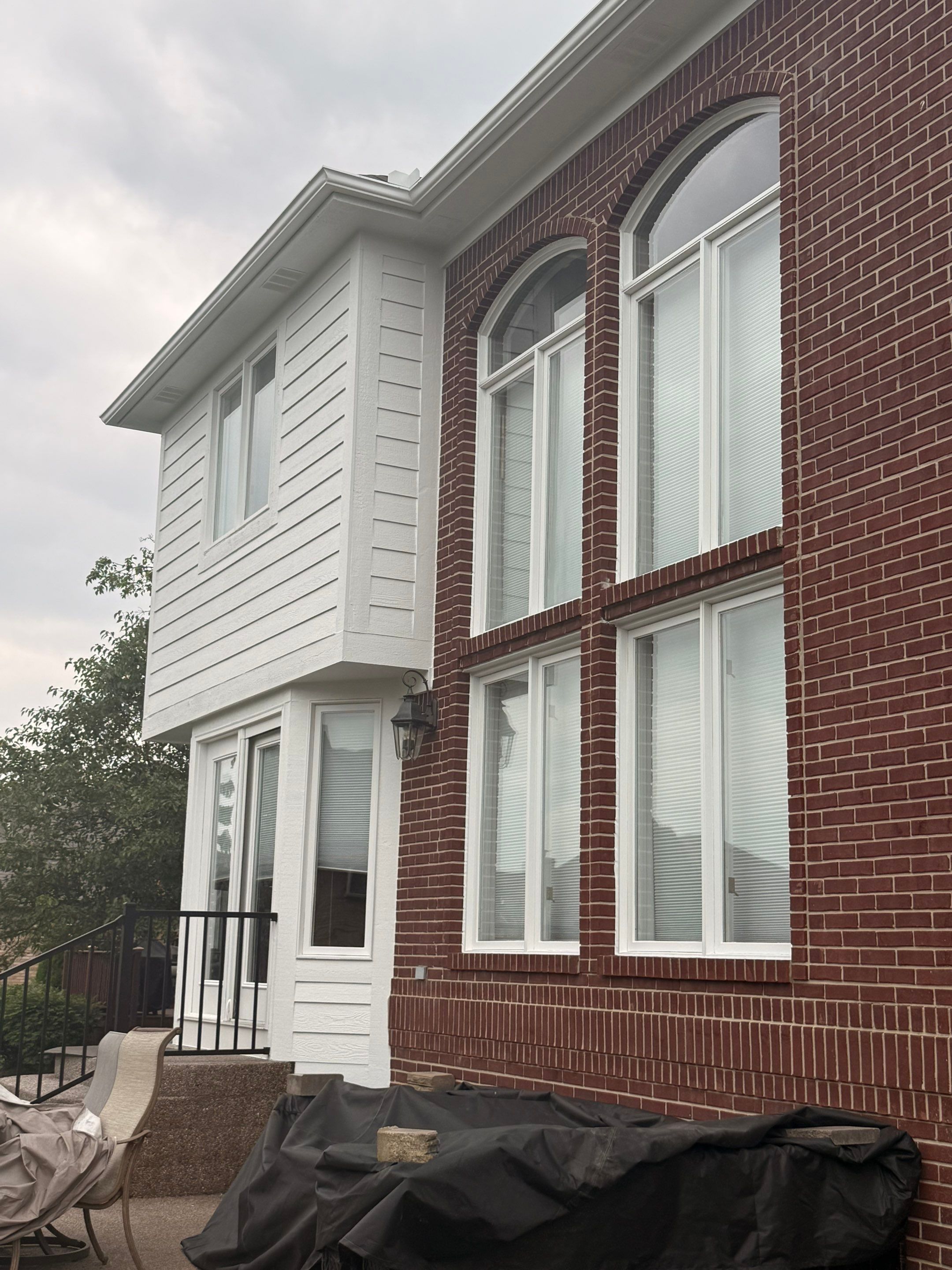 Siding and Trim Repair and Exterior Painting for a Macomb Brick Residence by Top Shelf Painter