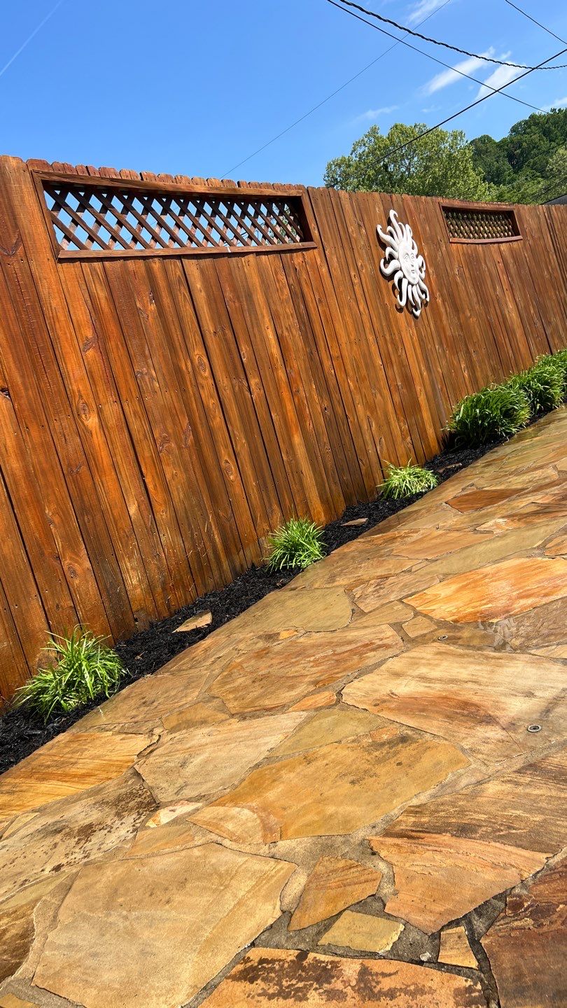 Liriope grasses, mulch and stone pavers by GrassBusters, Inc.