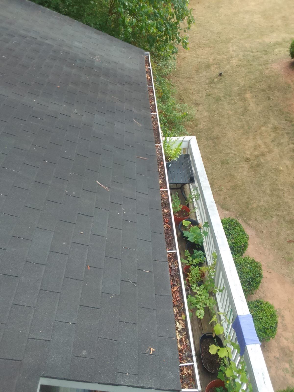 Commercial gutter cleaning Wake Forest & Rolesville, NC before photo with filled gutters