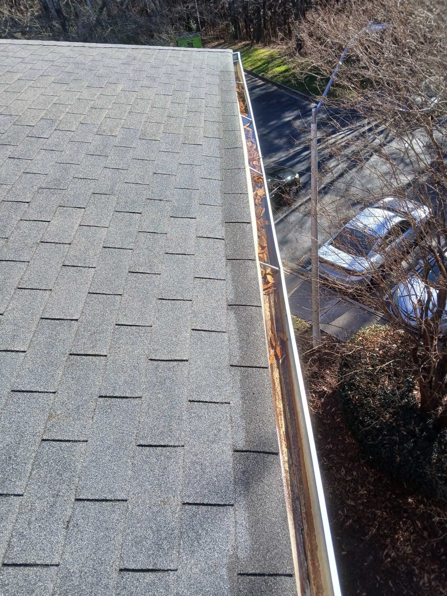 HOA gutter cleaning in Fuquay-Varina & Holly Springs, NC,before photo showing full gutters.
