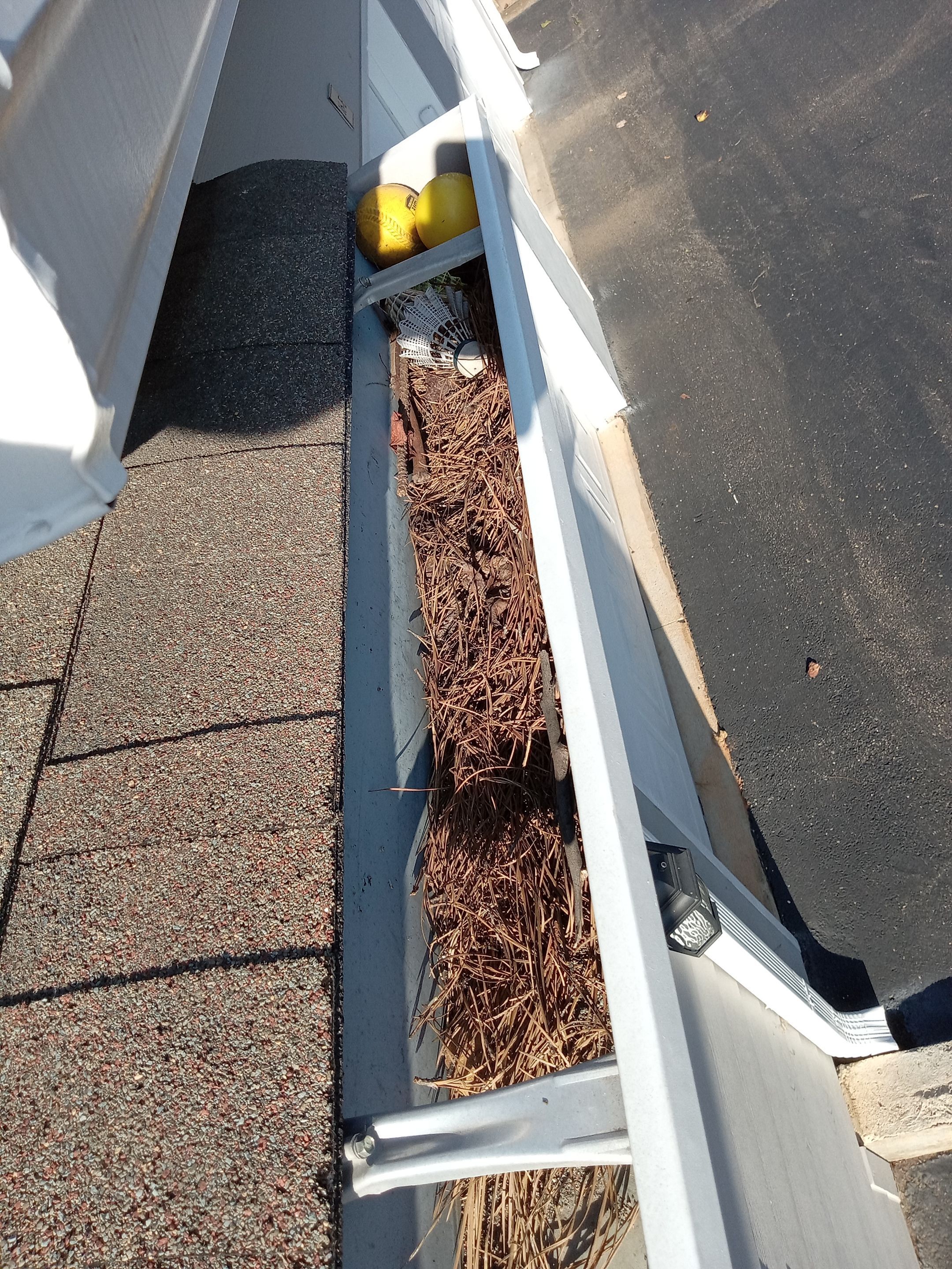 HOA gutter cleaning in Cumming & Forsyth County, GA,before  photo showing full gutters.