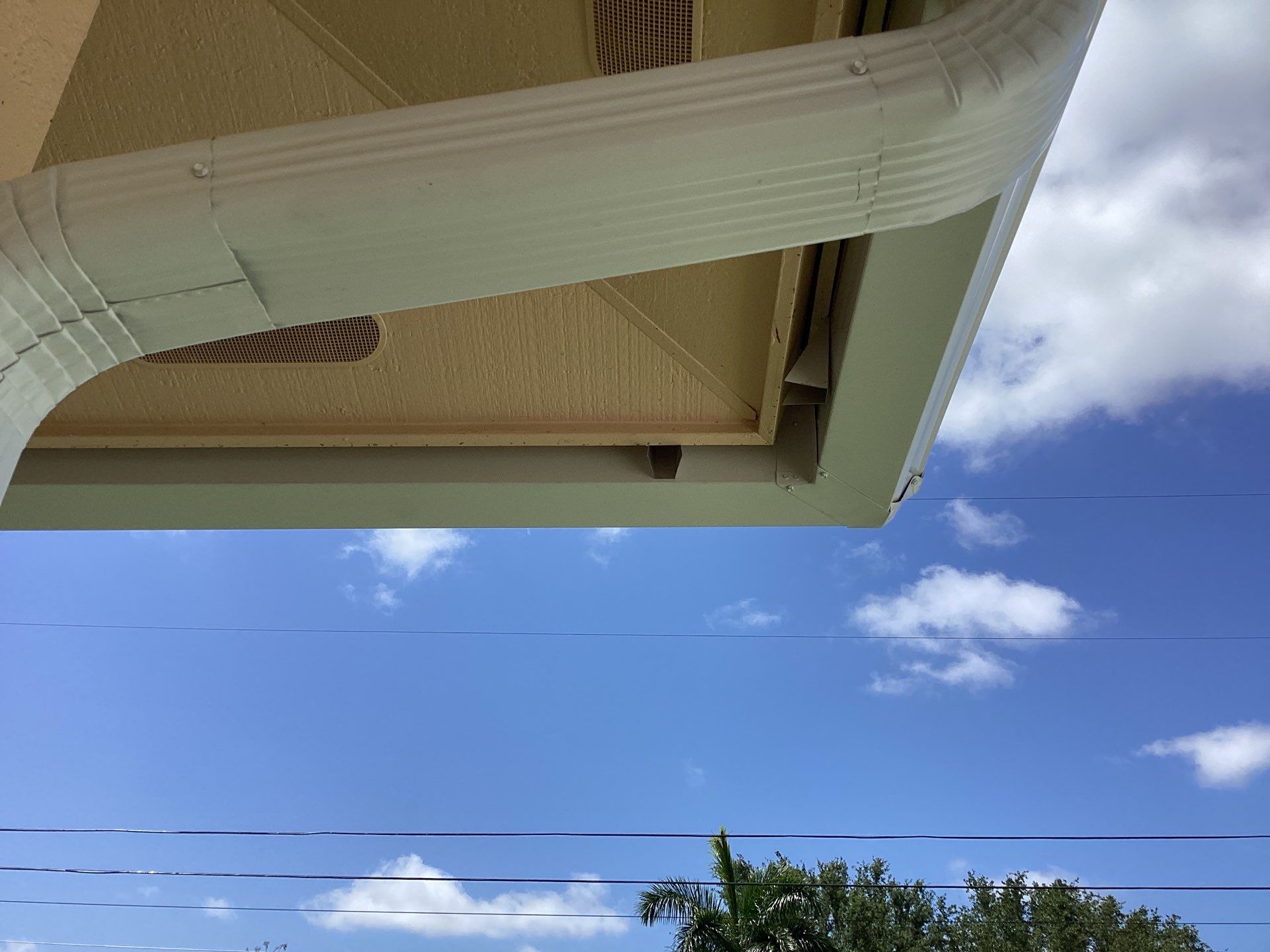 White K Style Seamless Gutters using 3X4 Elbow Downspout in Cape Coral FL by Gutter Professors