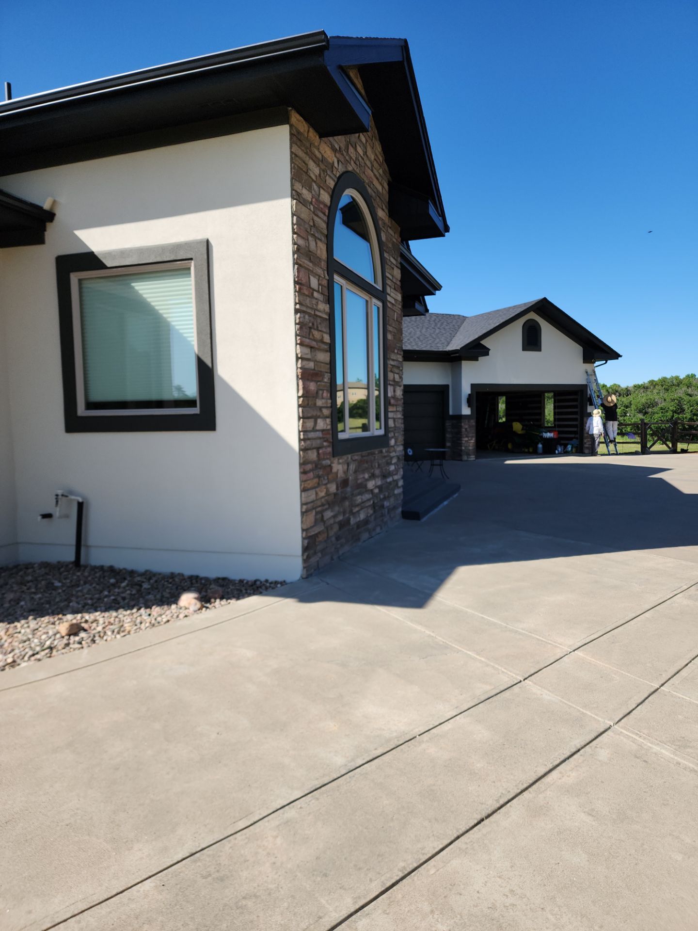 Castle Rock Elegance: White Stucco Exterior with Bold Tricorn Black by J&M Painting LLC
