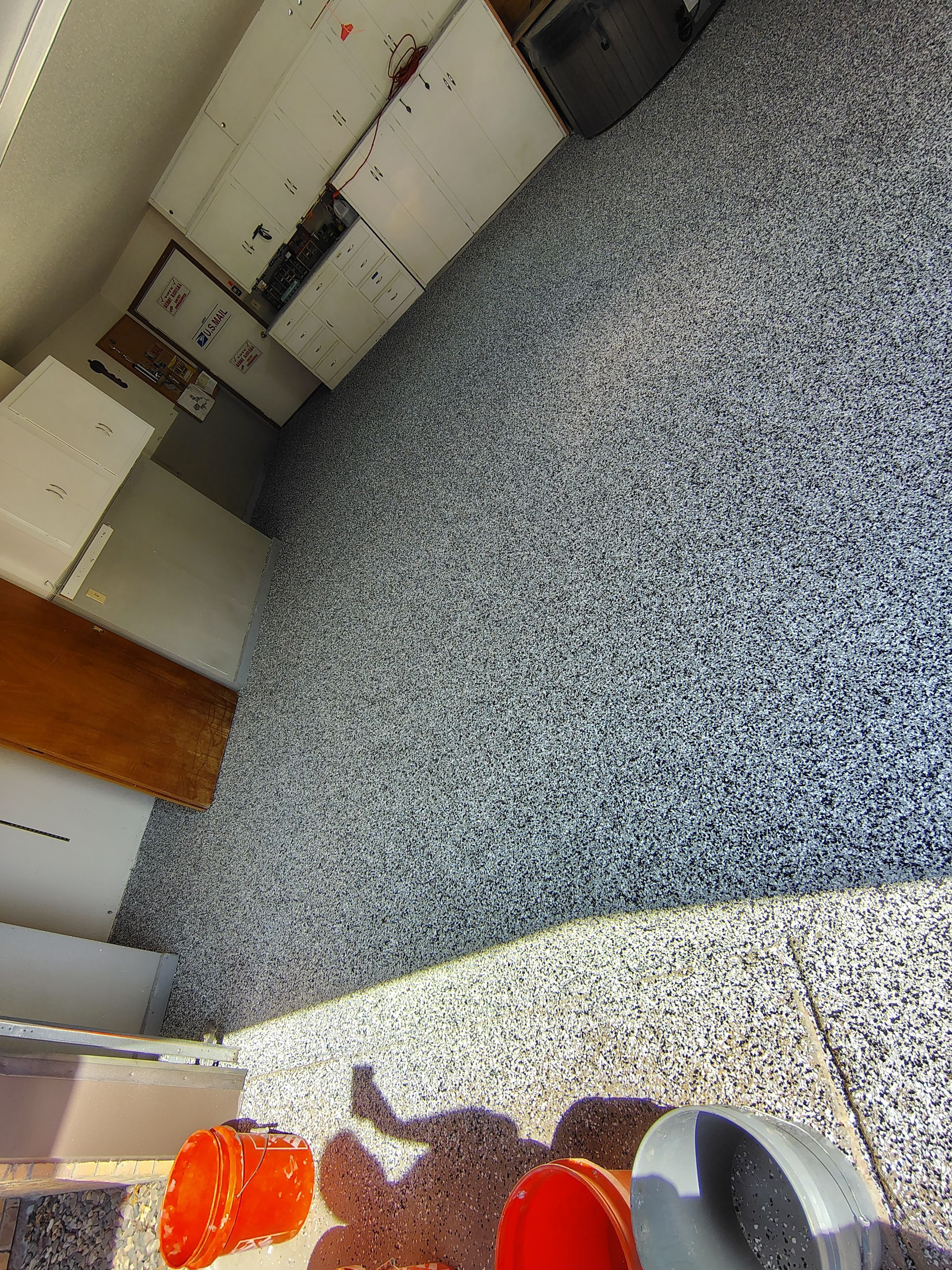 Domino Flake Garage Floor Coating Installation in Sioux Falls by Select Painting, Coatings & Garage Cabinets