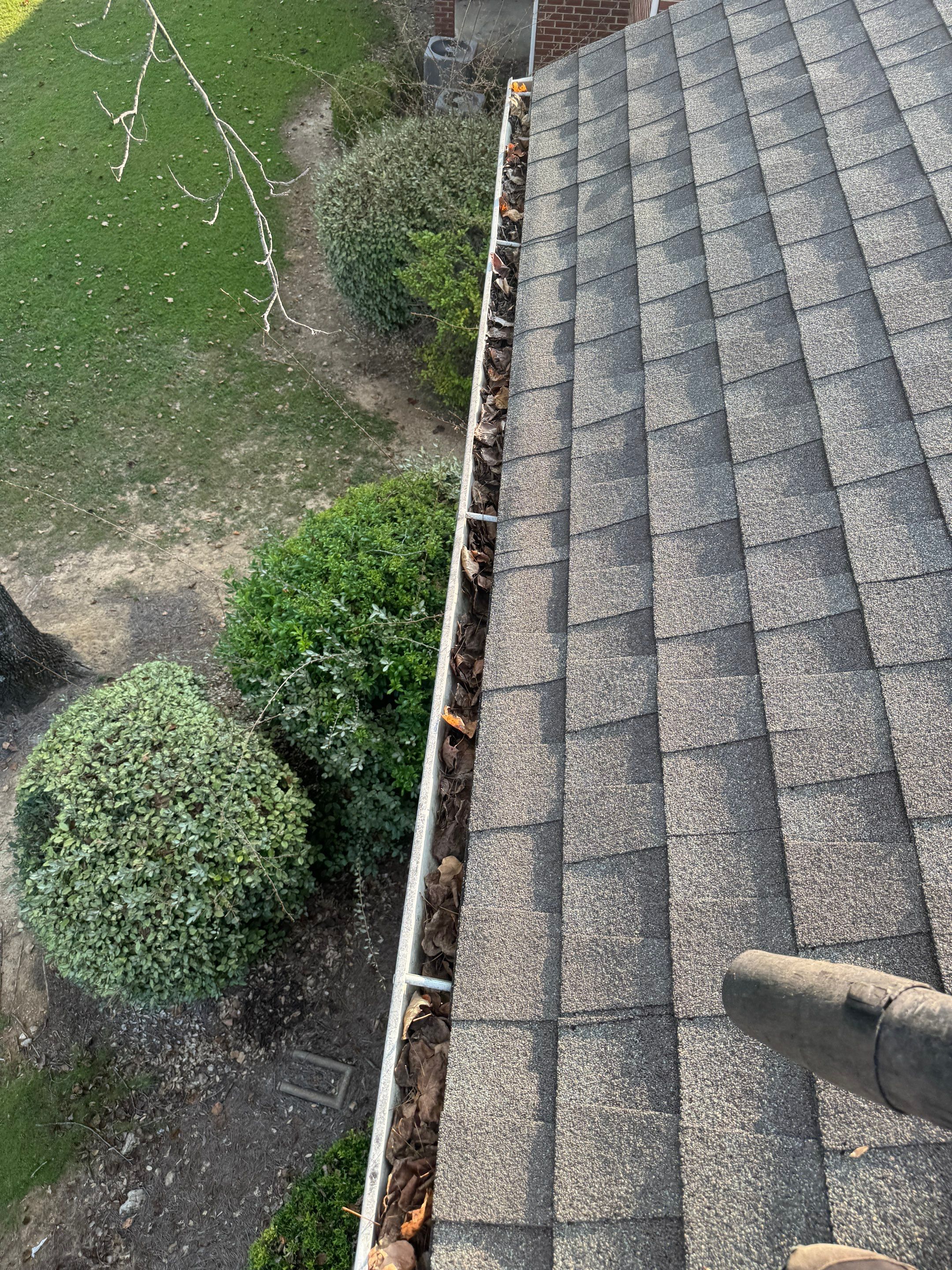 Commercial gutter cleaning Montgomery before photo with filled gutters