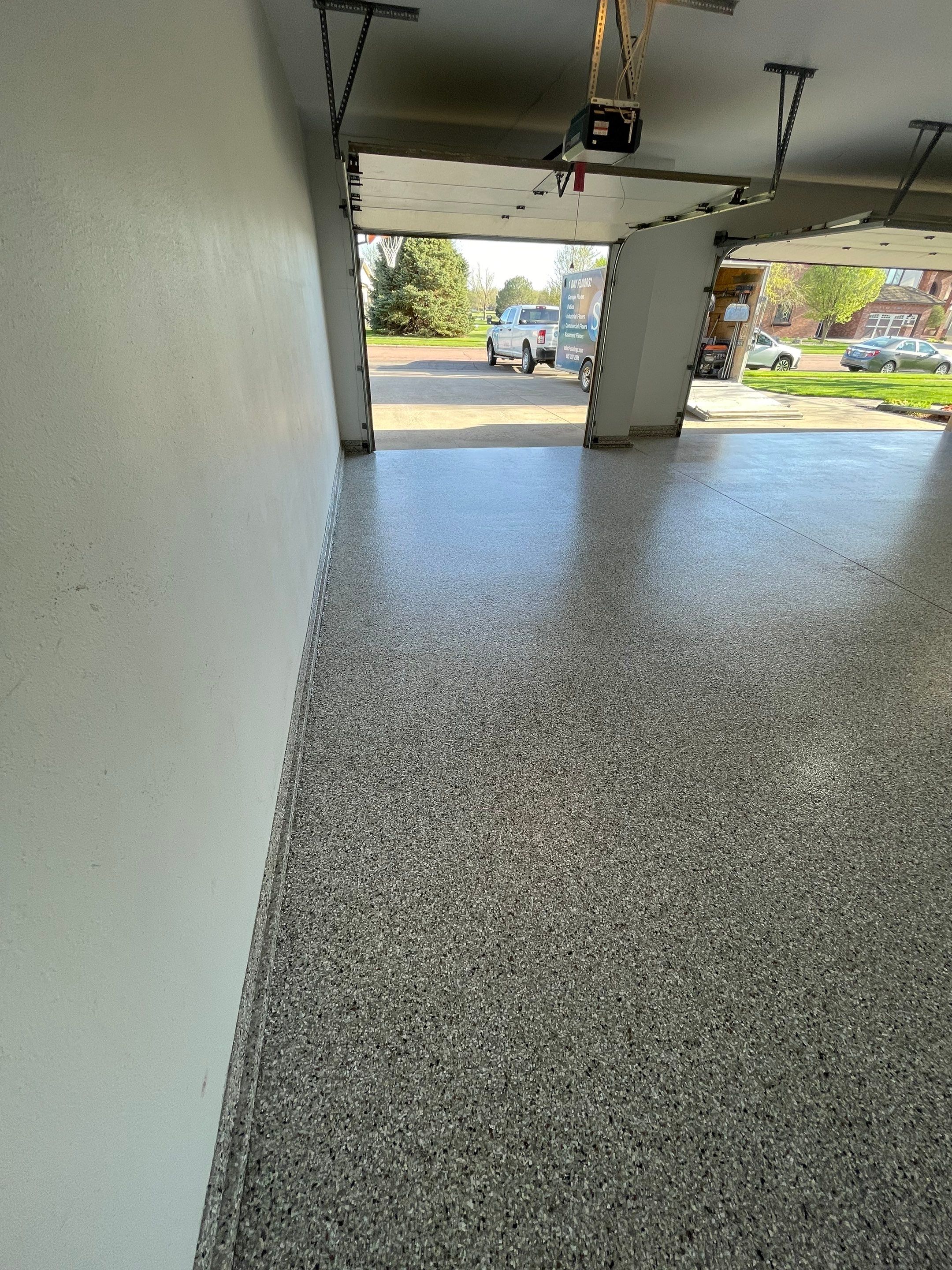Yankton Garage Floor Restoration with Gray Speckled Epoxy Coating by Select Painting, Coatings & Garage Cabinets