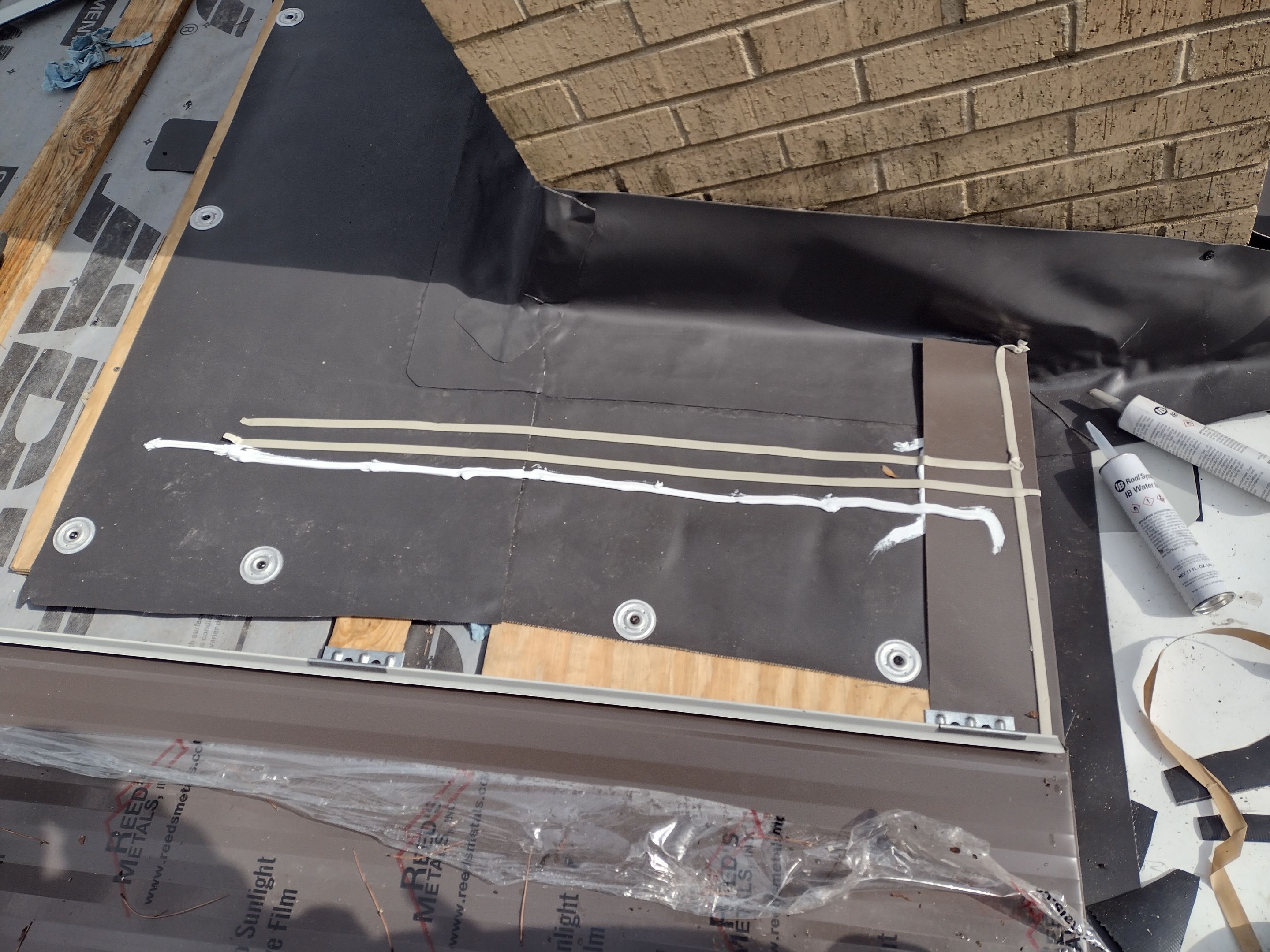 Residential Roofing Installation using PVC membrane and 24 gauge Standing Seam Metal by Hostetler Roofing