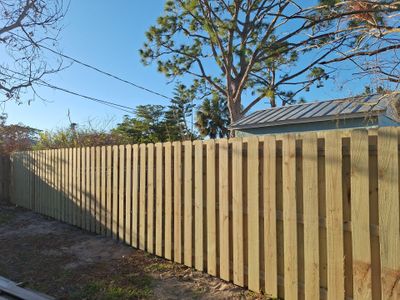 Wood Fence Installation using 6ft Pressure-Treated Wood Board-On-Board Privacy Fence with a 4Ft 3 Rail White Aluminum Fence