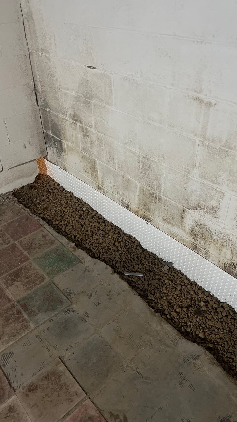 Interior drain tile system installation by ACE Waterproofing & Basement Solutions