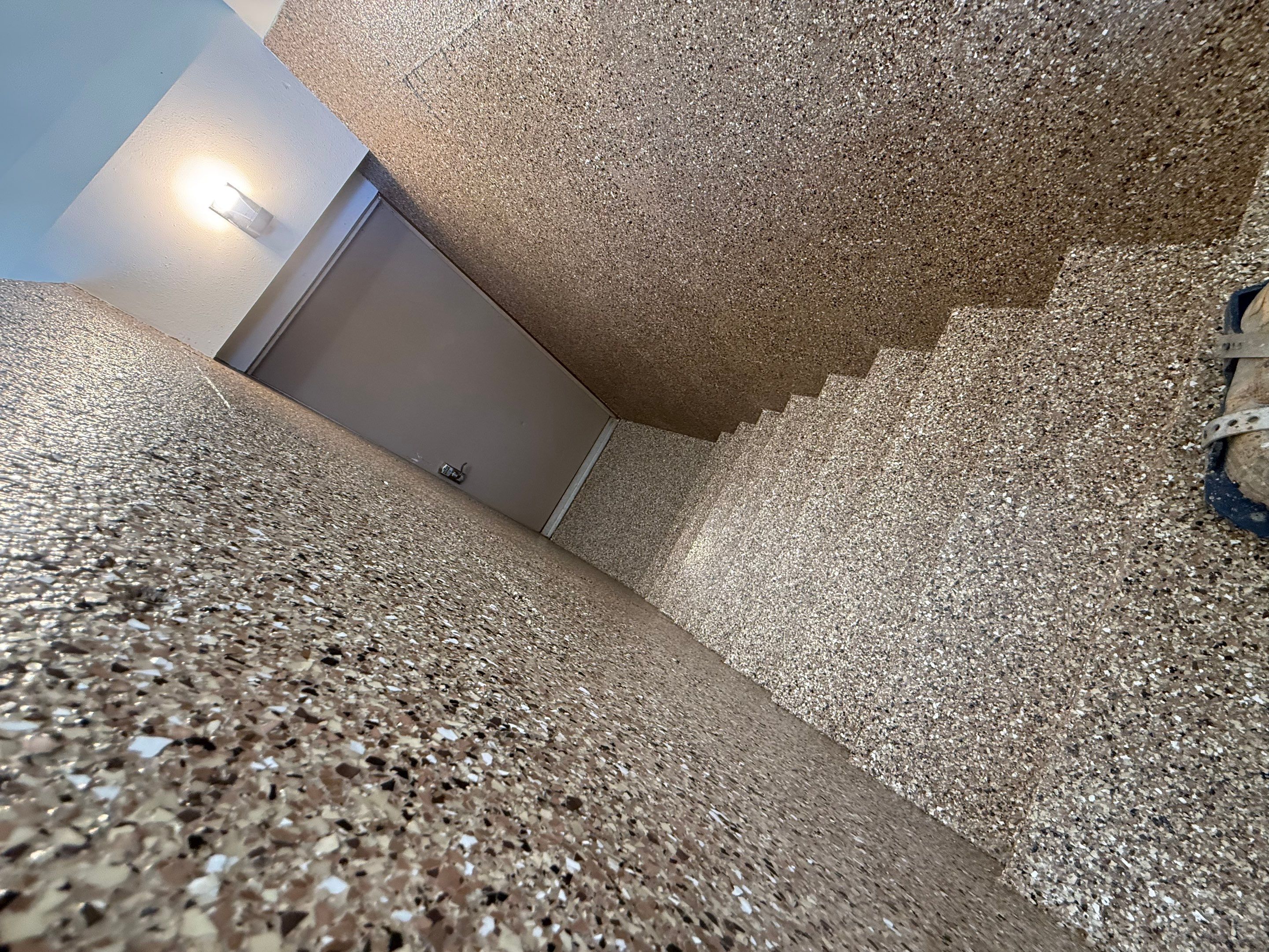 Custom Polyaspartic Garage Floor and Stairwell Coating in Pipestone by Select Painting, Coatings & Garage Cabinets
