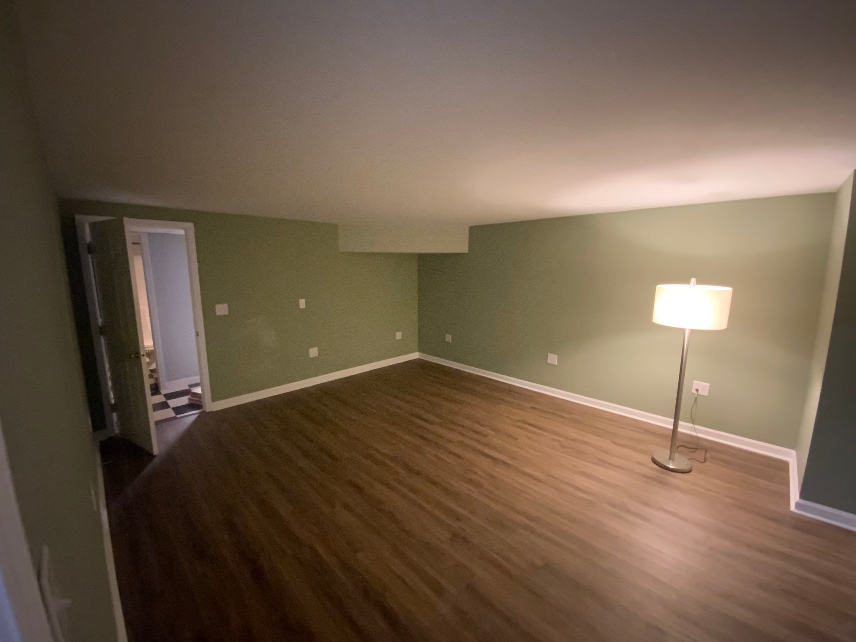 Finished Basement Room Transformation with Wood-Look Flooring in Roswell by Swift Home Renovations