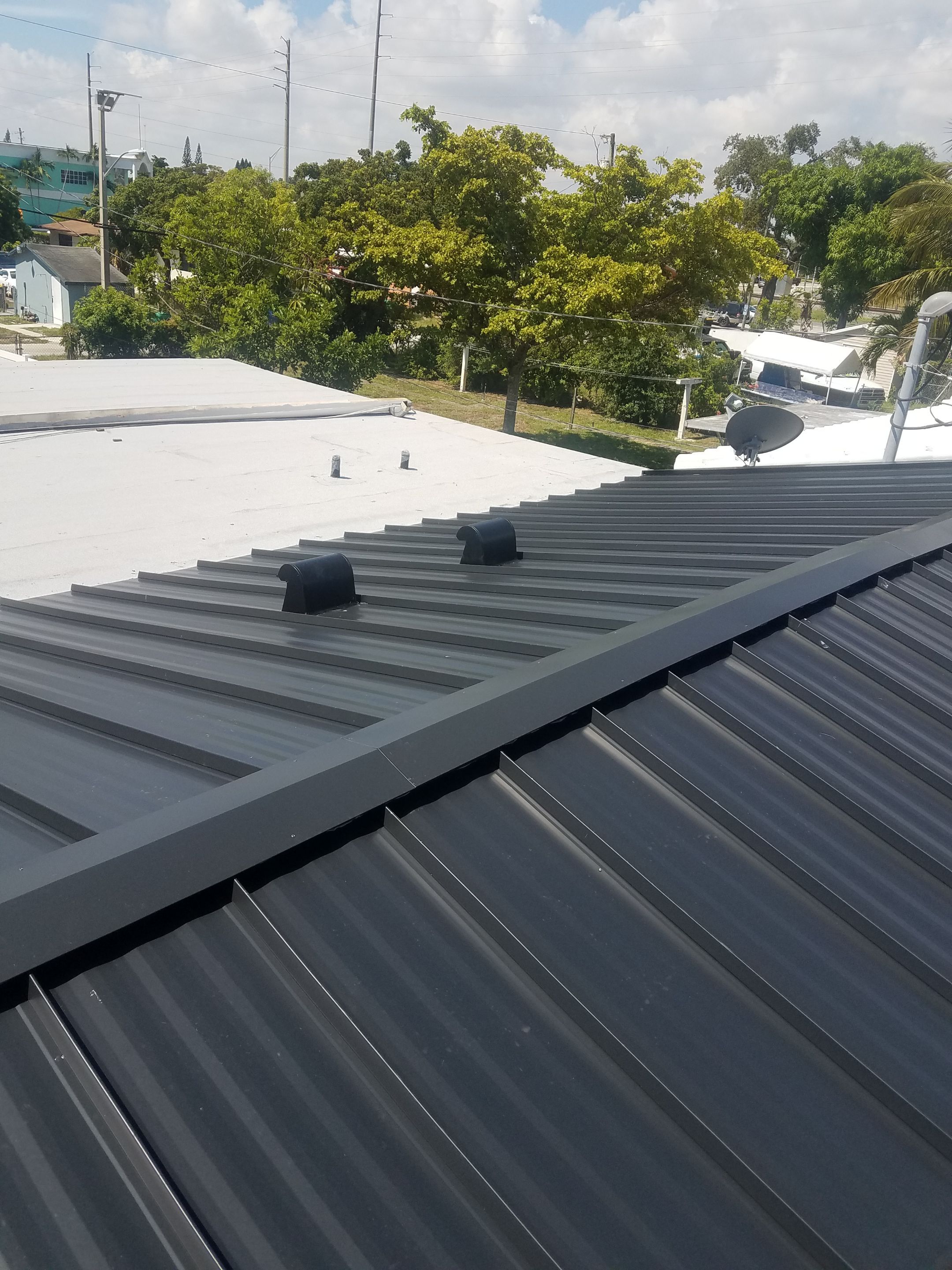 Standing Seam Metal & Flat Re-Roof using 1.5" Nail Strip 24ga Black Matte Kynar Coated Standing Seam Metal Panels by Morton Roofing, Inc.