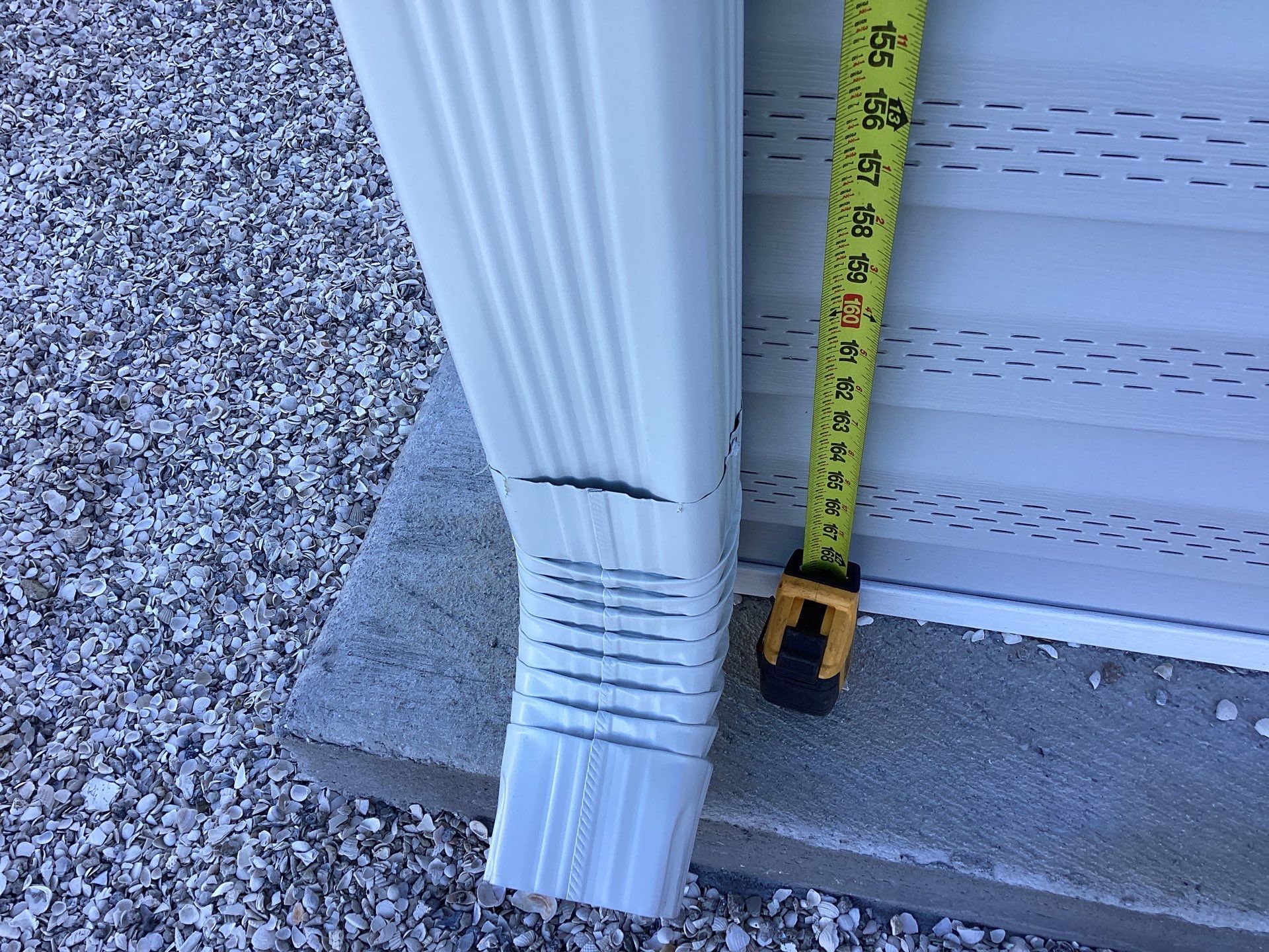 White Downspouts Installation in St. James City by Gutter Professors