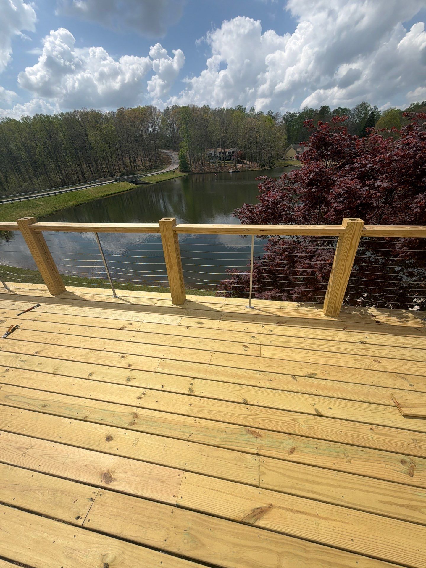 Cumming, GA Lake House Deck Resurface and Extension using Pressure Treated Pine and Skyline Cable Railing by Nelson Exteriors 
