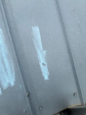 Close up of metal roof panel with chalk markings