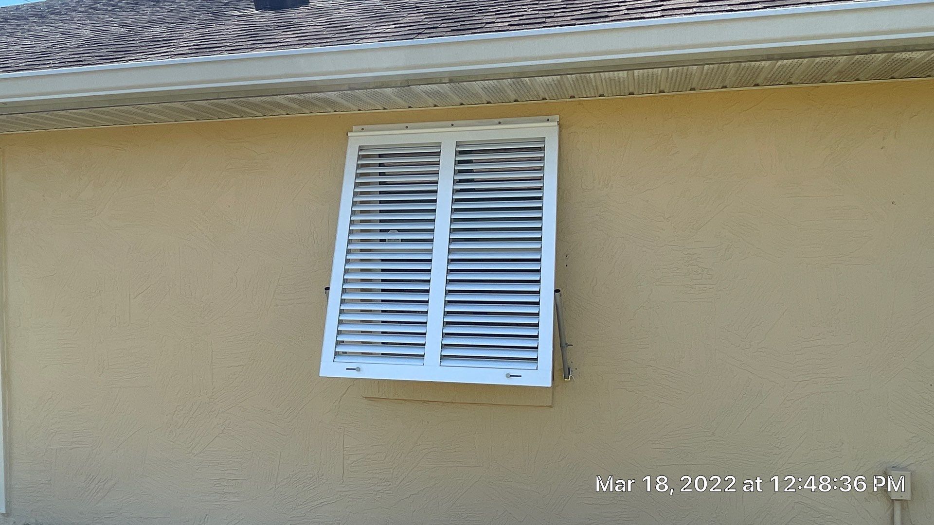 Bahama Shutters with front slide locking pin by Smart Guard Shutters