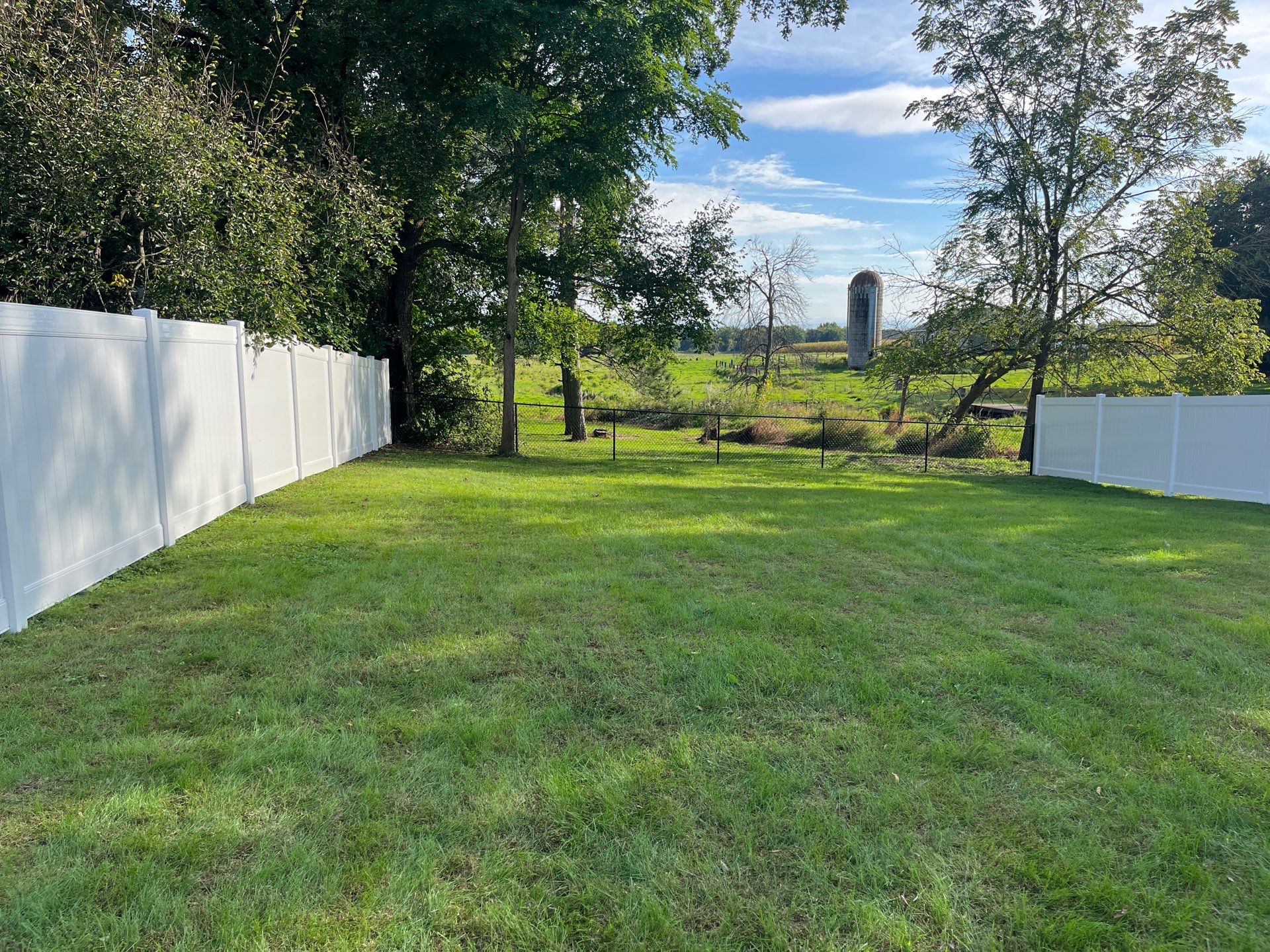 White Vinyl Privacy Fence and Black Chain Link Installation in Sumner by Perfect Picket Fence and Stain