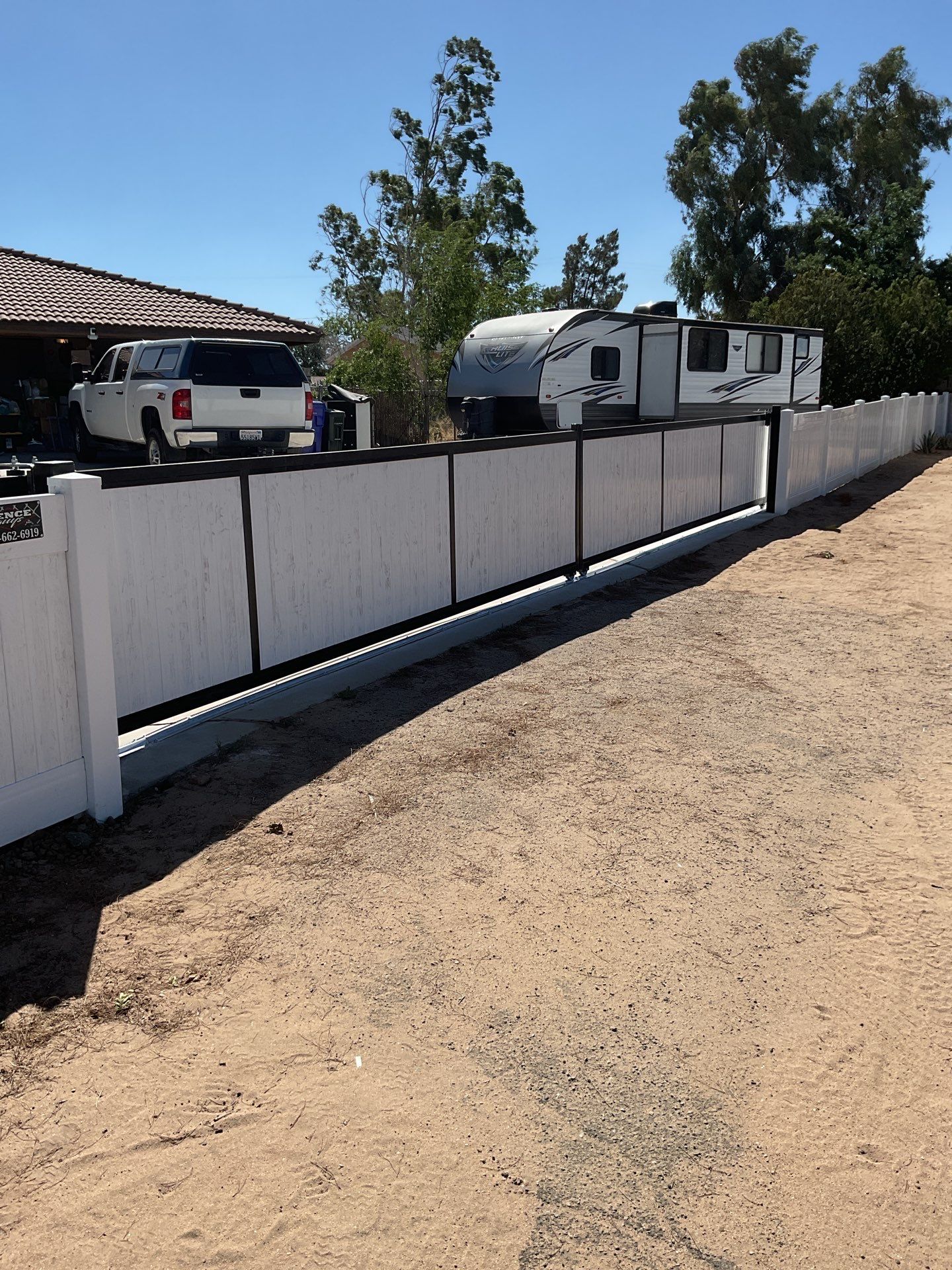 4ft White Vinyl Fence with Solar Power Motorized Gate by Fence Guys Inc.