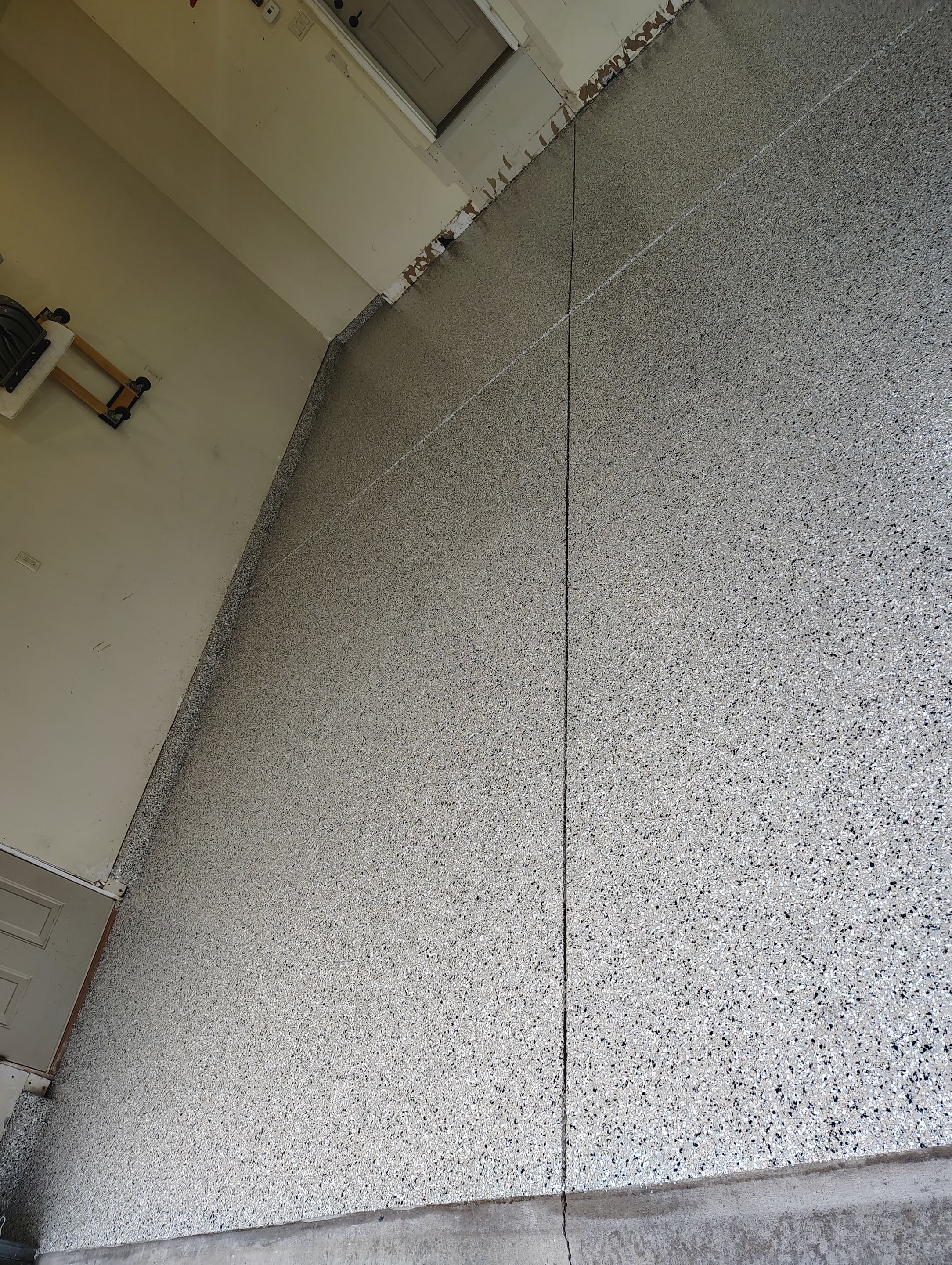 Sioux Falls Garage Floor Repair and Speckled Epoxy Coating Installation by Select Painting, Coatings & Garage Cabinets