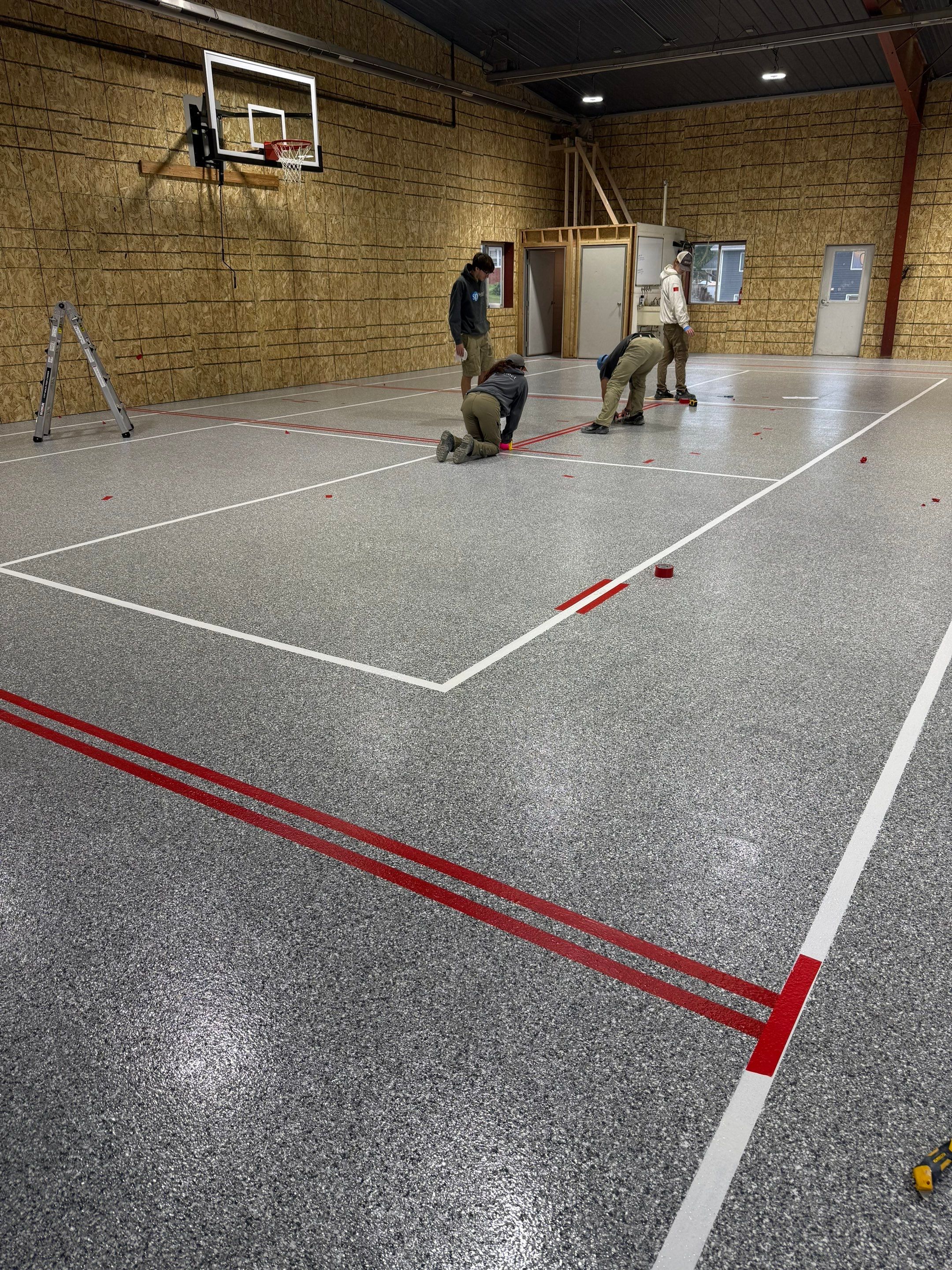 Custom Polyurea Shop Floor with Basketball Court Lines in Rock Valley by Select Painting, Coatings & Garage Cabinets