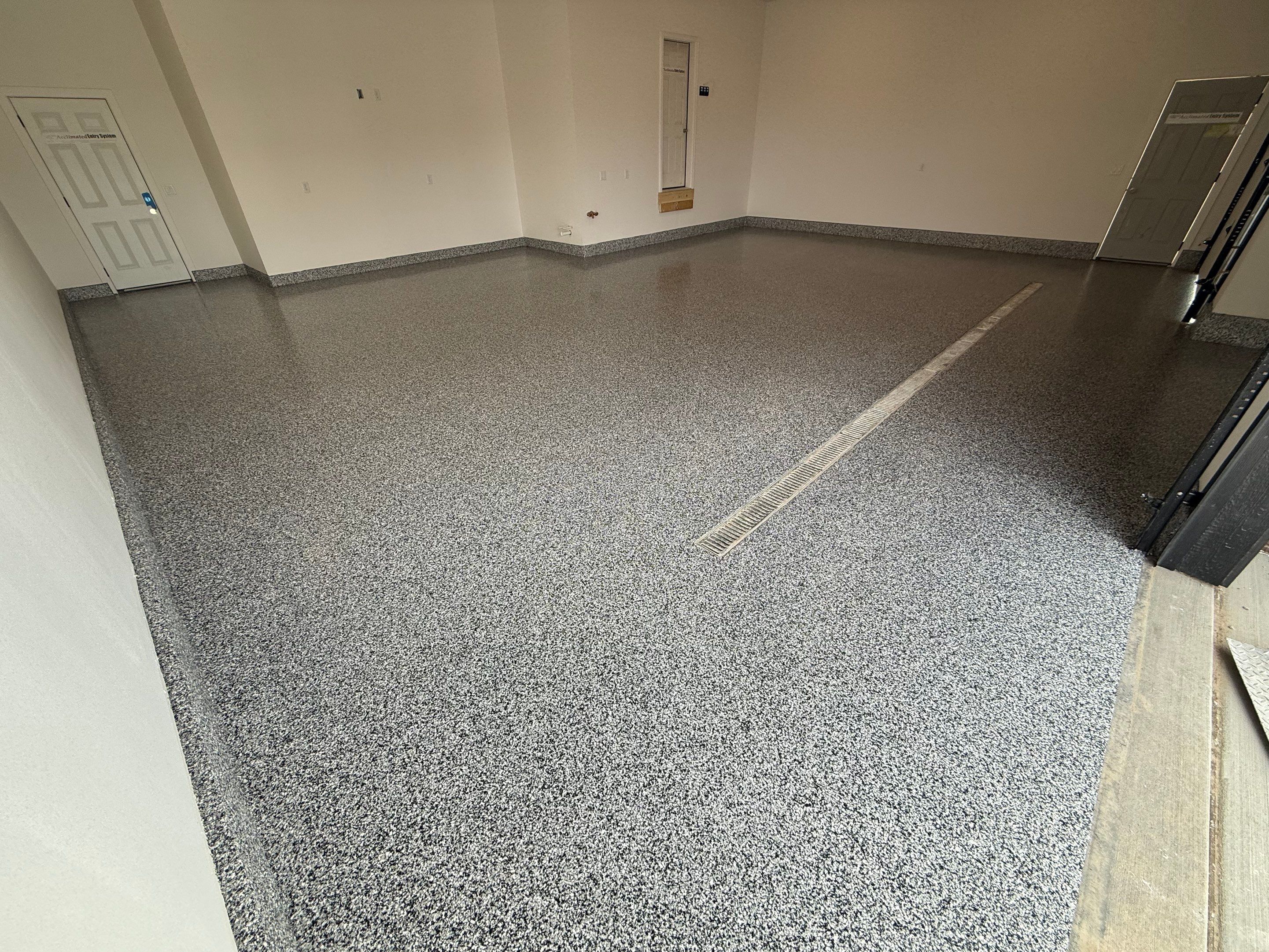 Multi-Car Garage Epoxy Floor Coating and Concrete Finishing in Sioux Falls by Select Painting, Coatings & Garage Cabinets