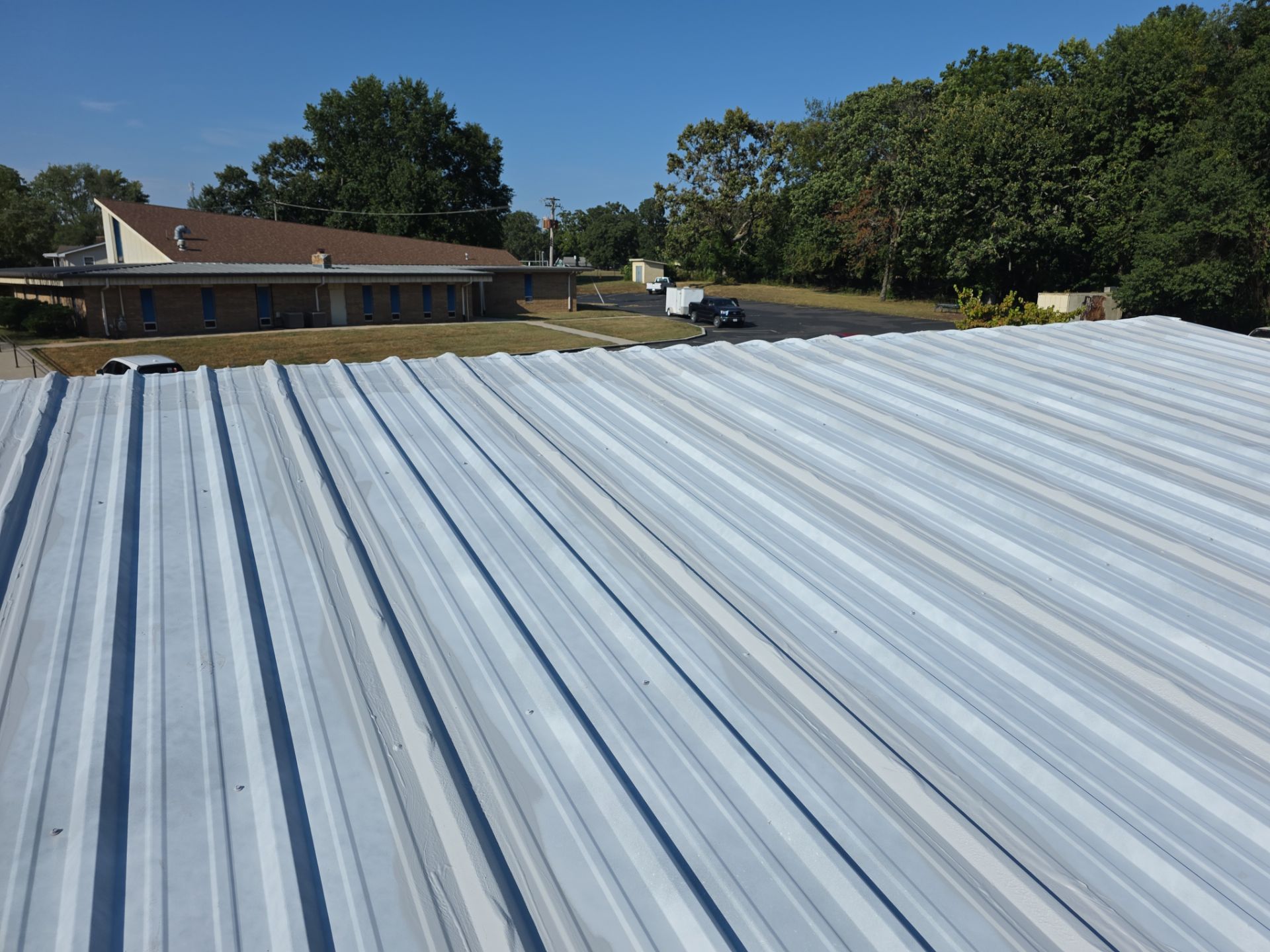 Commercial Roofing Install - Metal Coatings Restoration System  - Color White  by Titan Commercial & Residential Roofing 