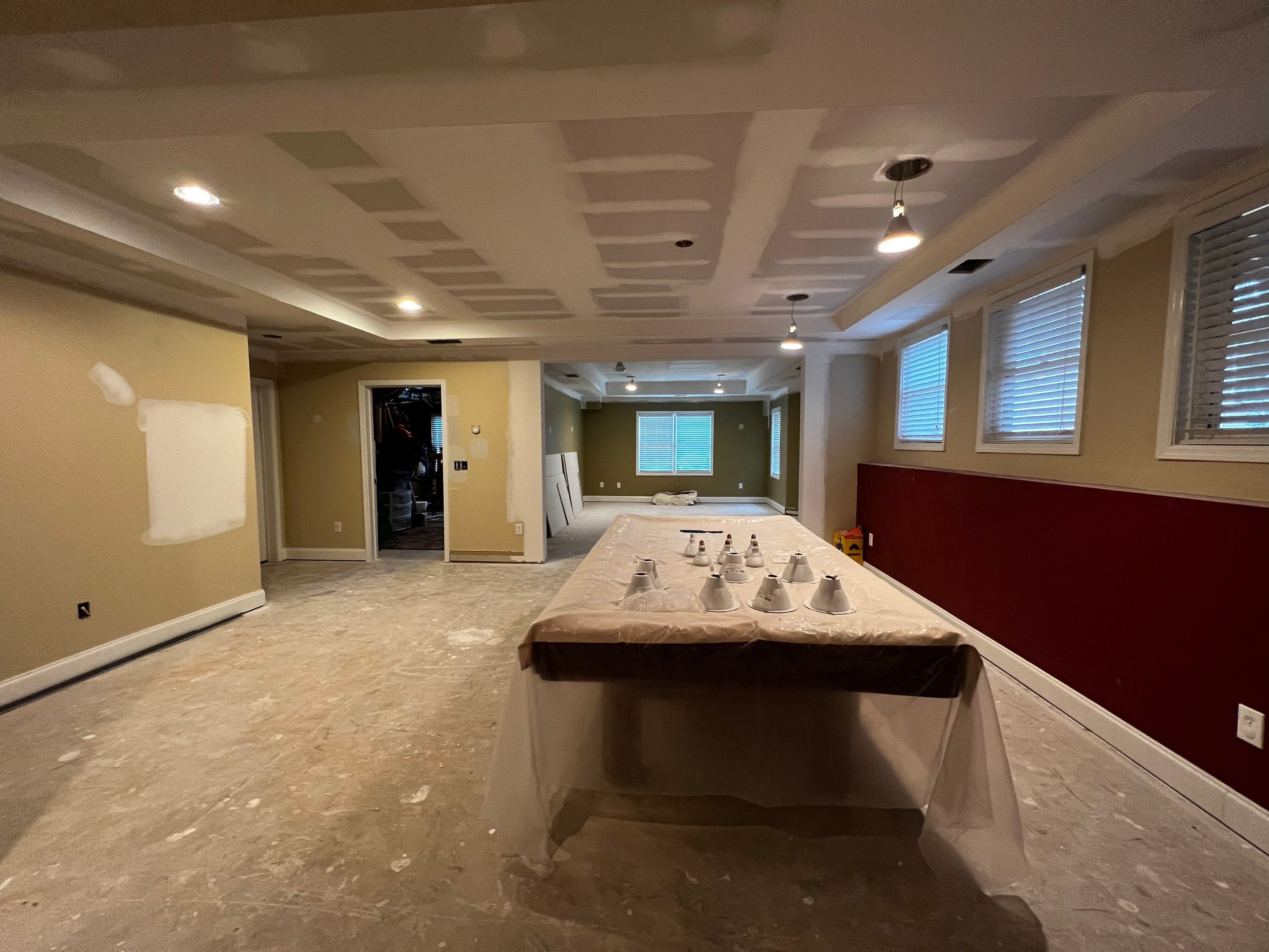 Modern Basement Remodeling in Woodstock with Custom Live-Edge Bar by Swift Home Renovations