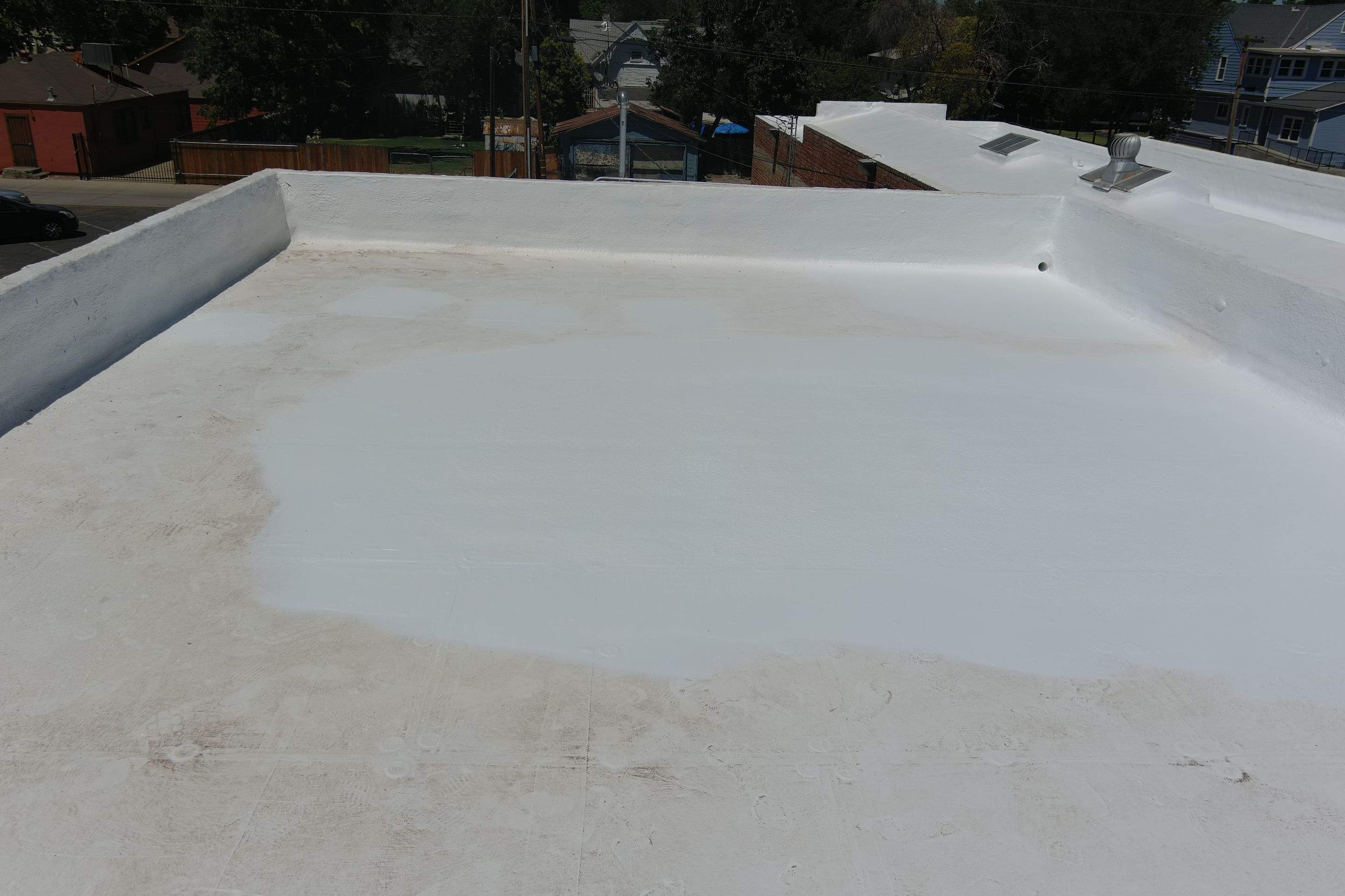 Commercial Roofing Installation using Conklin BenchPly system with PUMA top coat (imbedded fabric system) by Straight Edge Roofing Inc
