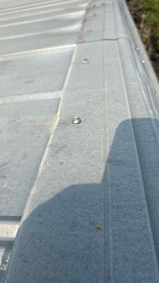 Close up of a standing seam metal roof panel.