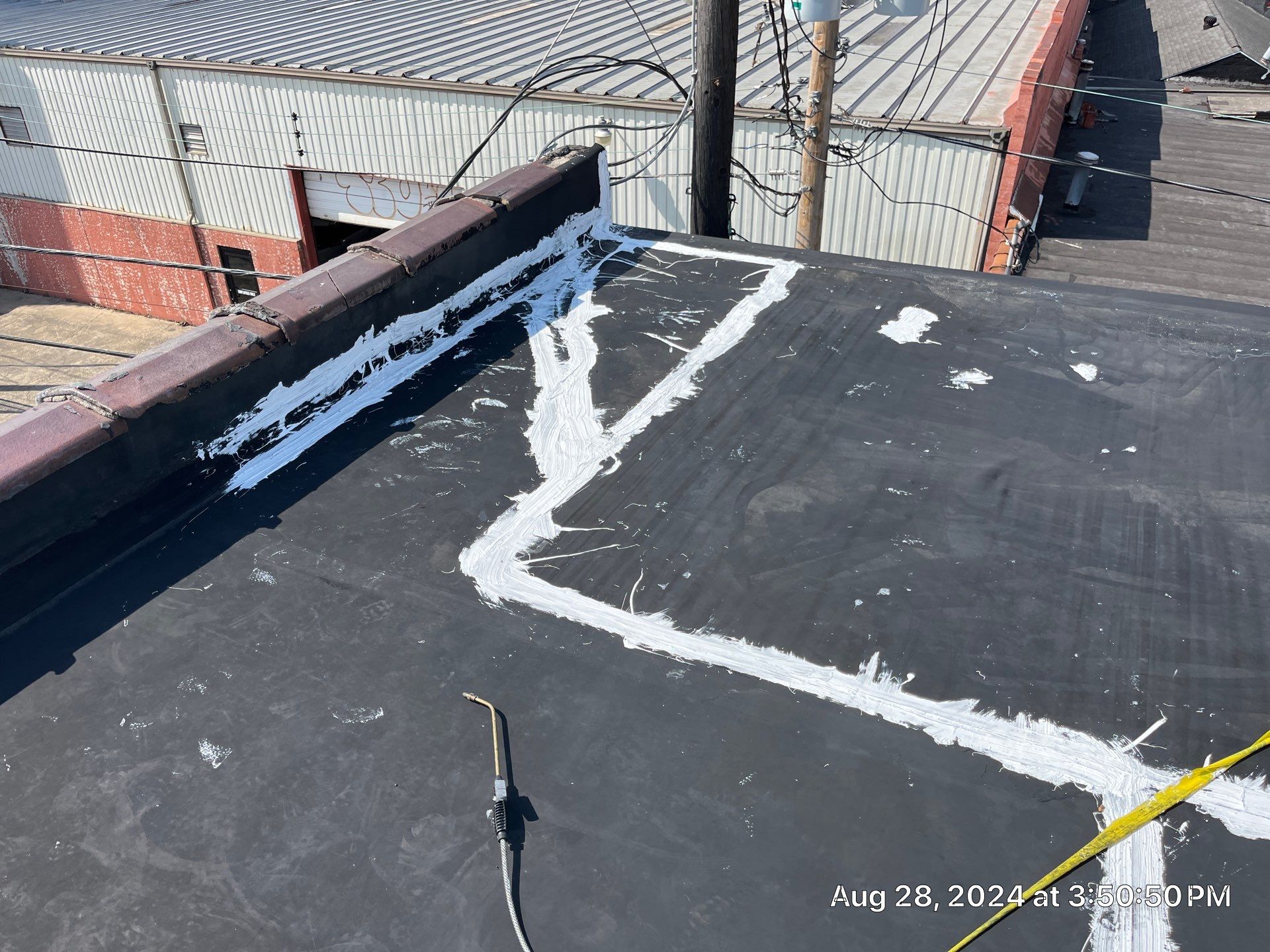 Commercial Roofing Installation using smartcoat Roof coating by Fahey Roofing + Contracting