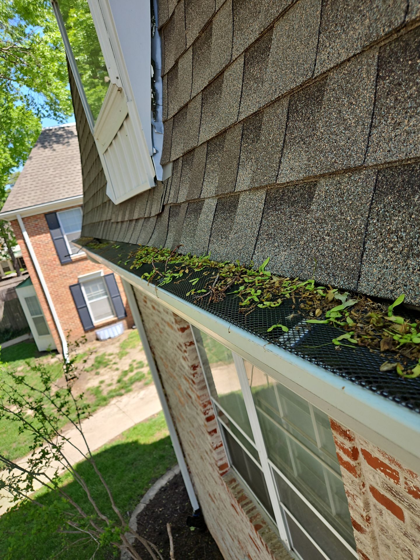 Commercial gutter cleaning Overland Park, KS before photo with filled gutters