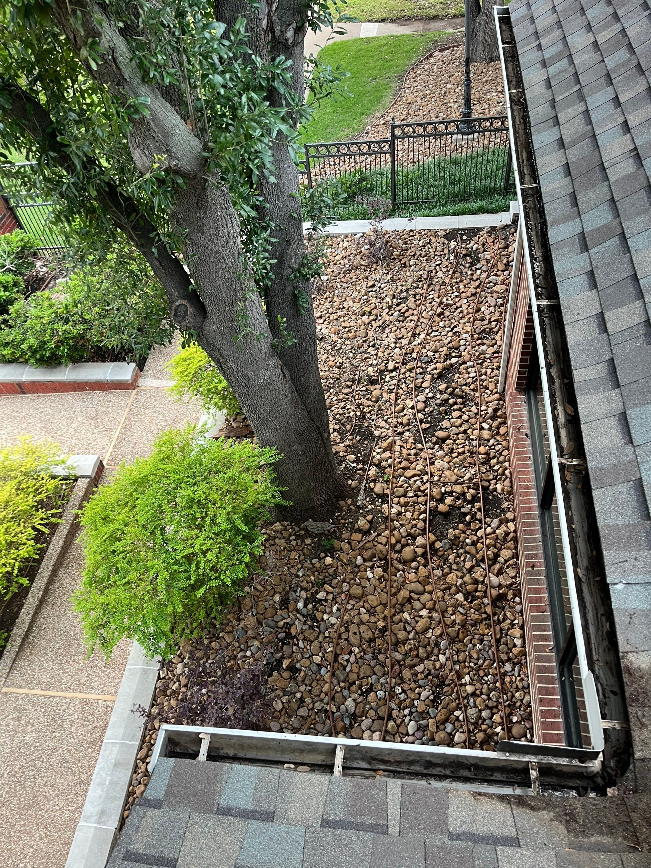 HOA gutter cleaning in Allen, TX, after  photo showing full gutters.